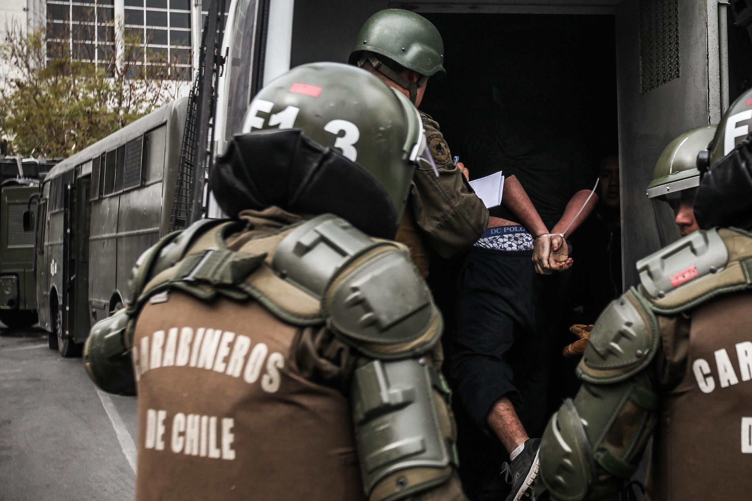 Chilean officials arrest a person on September 5, 2013, in Santiago, Chile. | Source: Getty Images