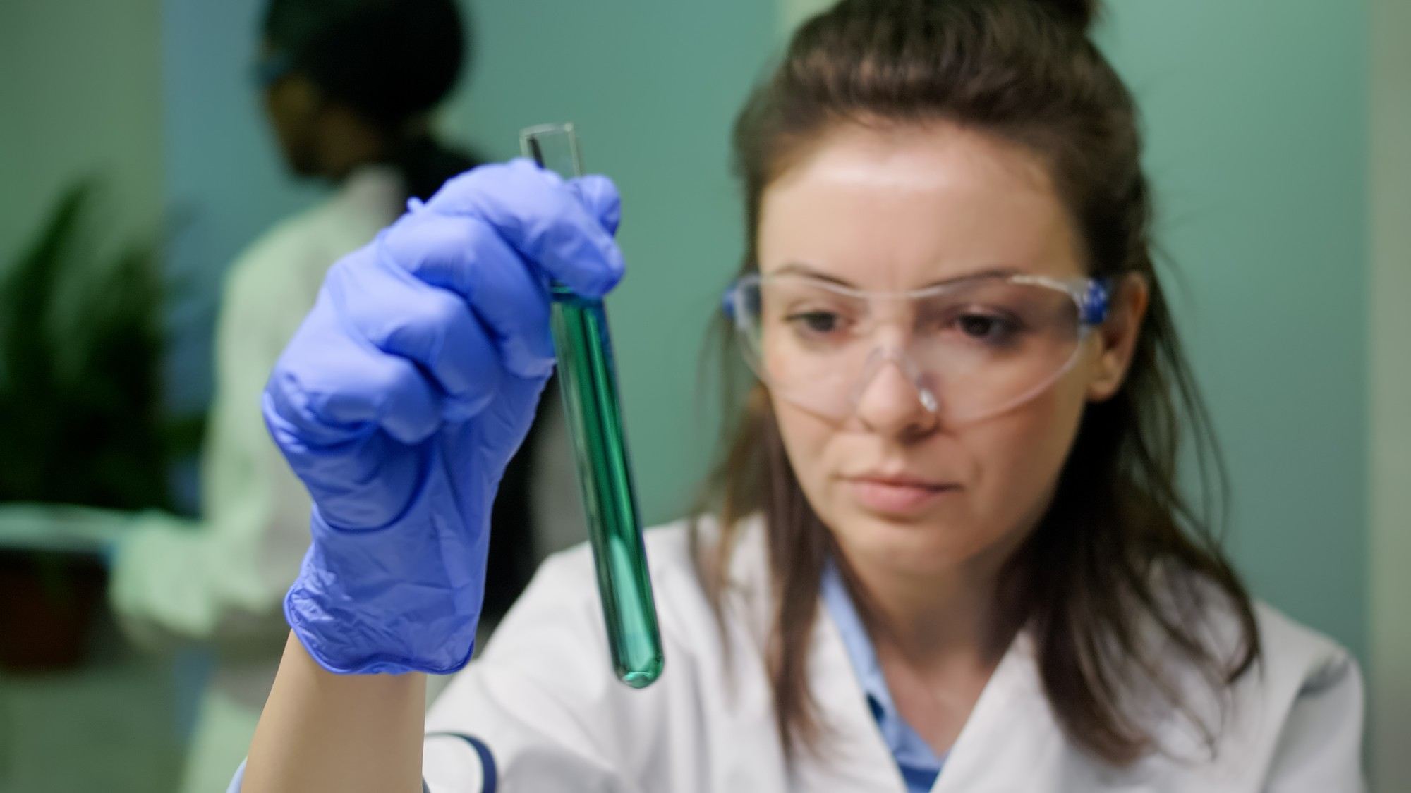 A person holding a test tube in a lab | Source: Freepik