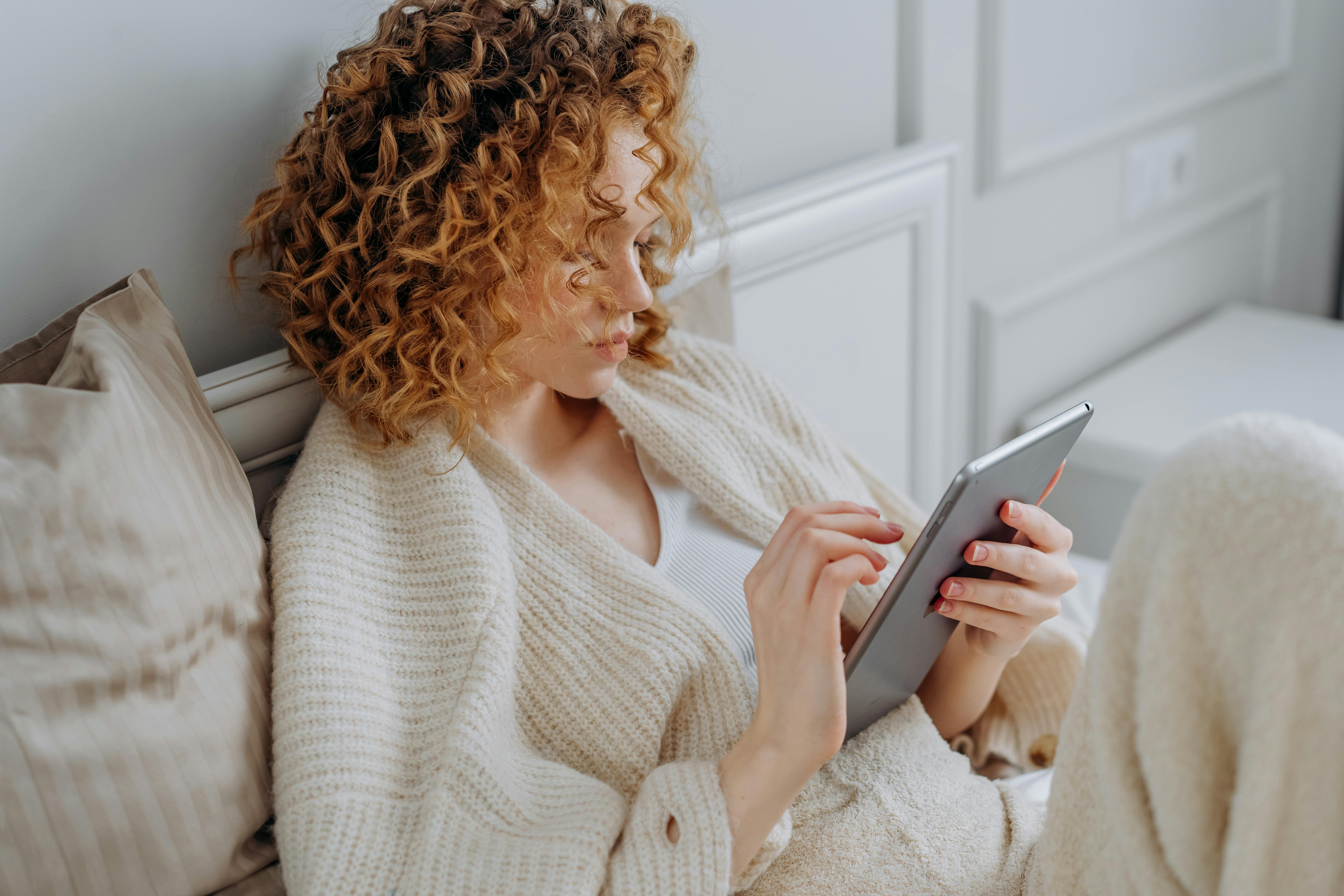 A bored woman in a tablet | Source: Pexels