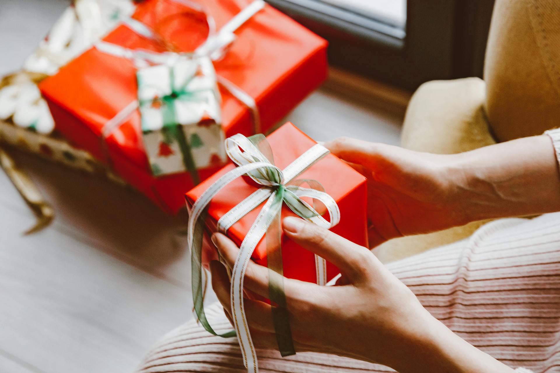 A woman opening a Christmas gift | Source: Pexels