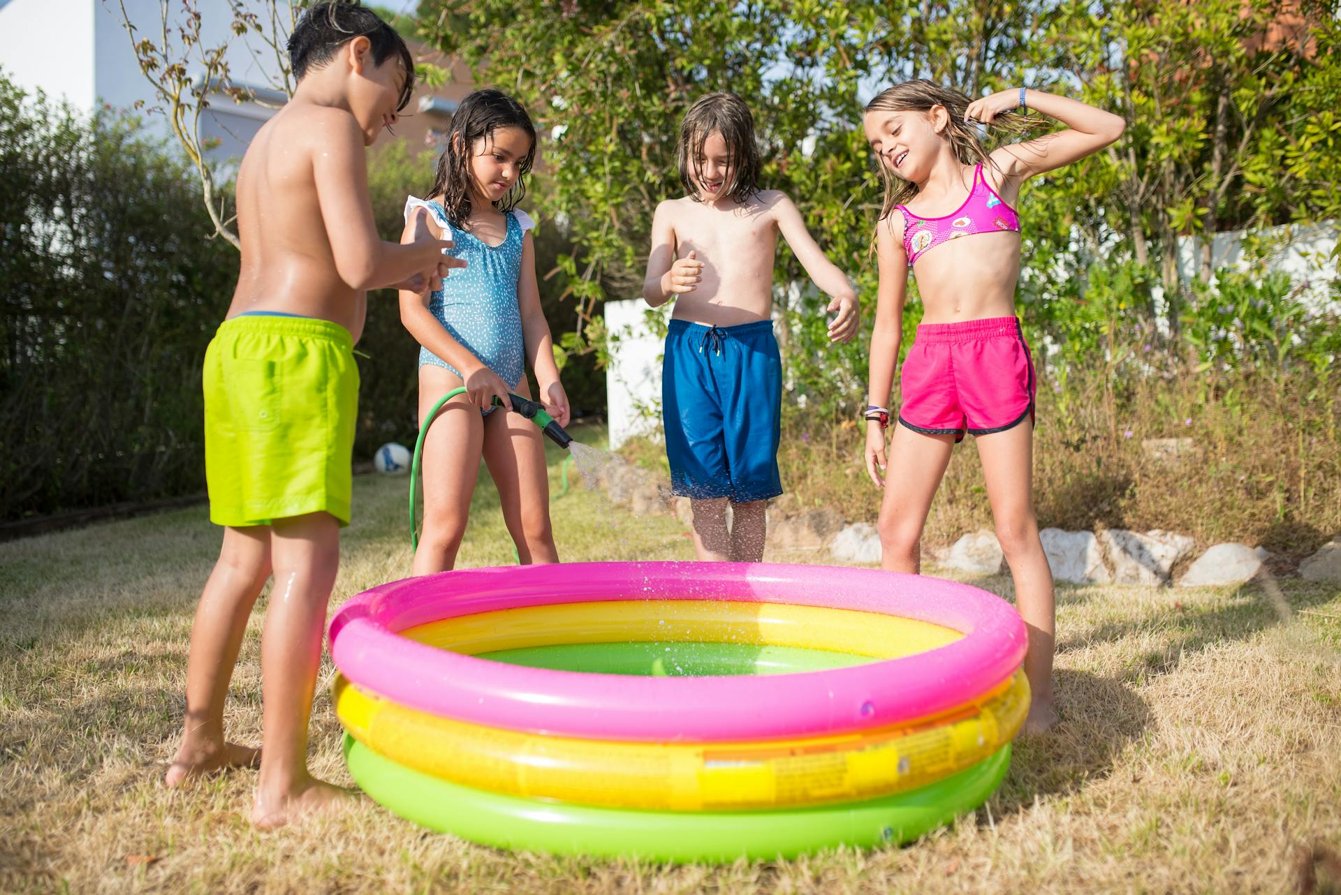 Children standing around an inflatable pool | Source: Pexels