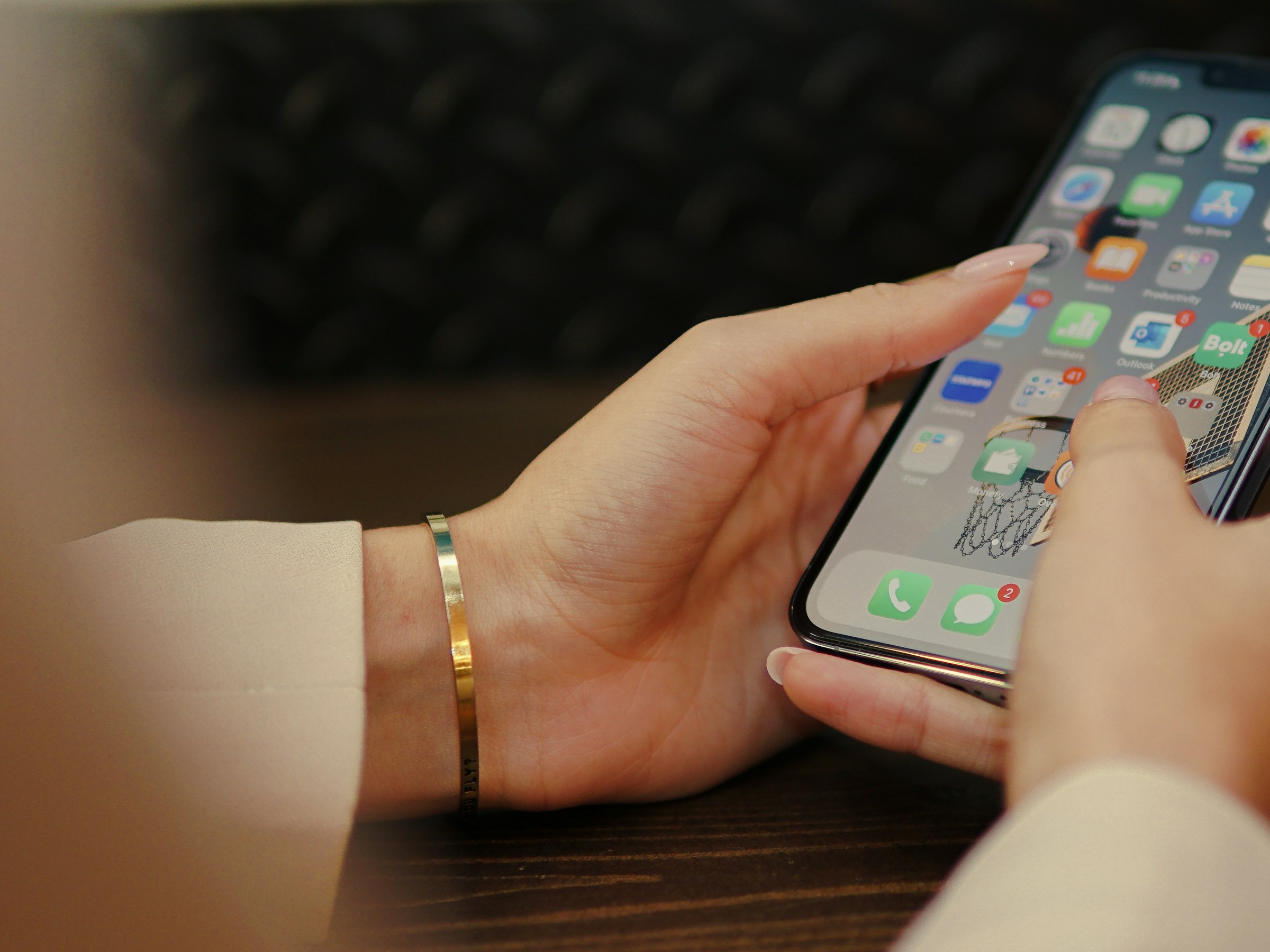 A woman holding a smartphone in her hands | Source: Pexels