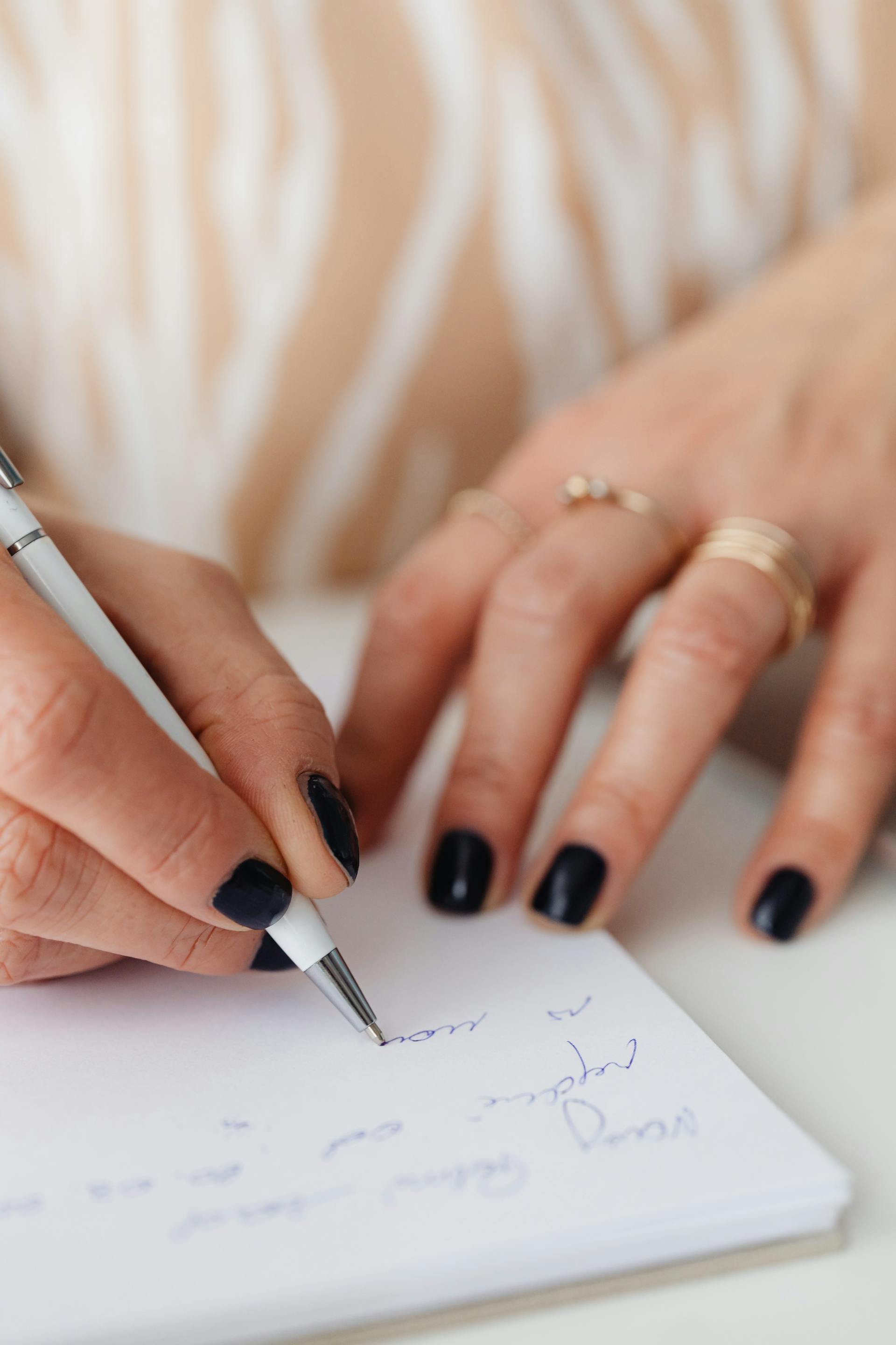 A woman writing in a notebook | Source: Pexels