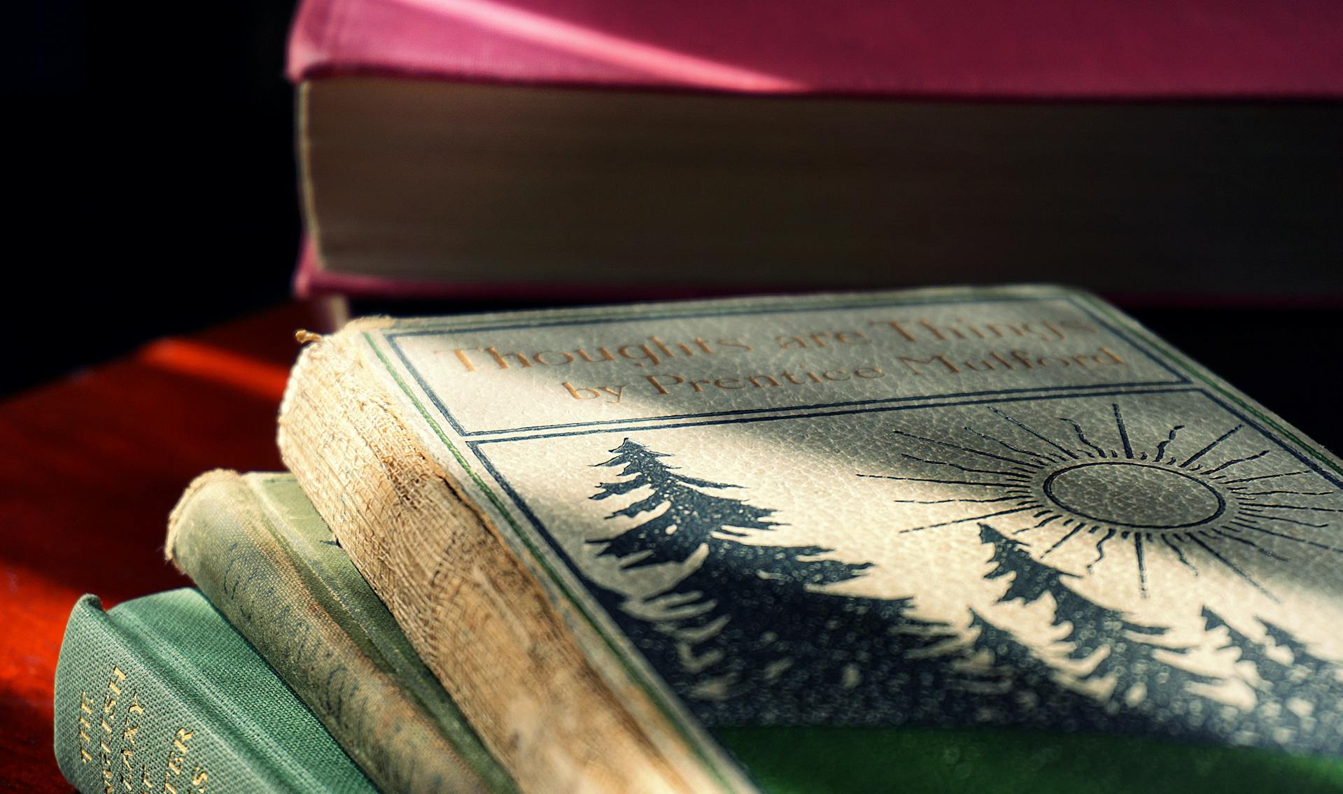 A closeup photo of piled hardcover books | Source: Pexels