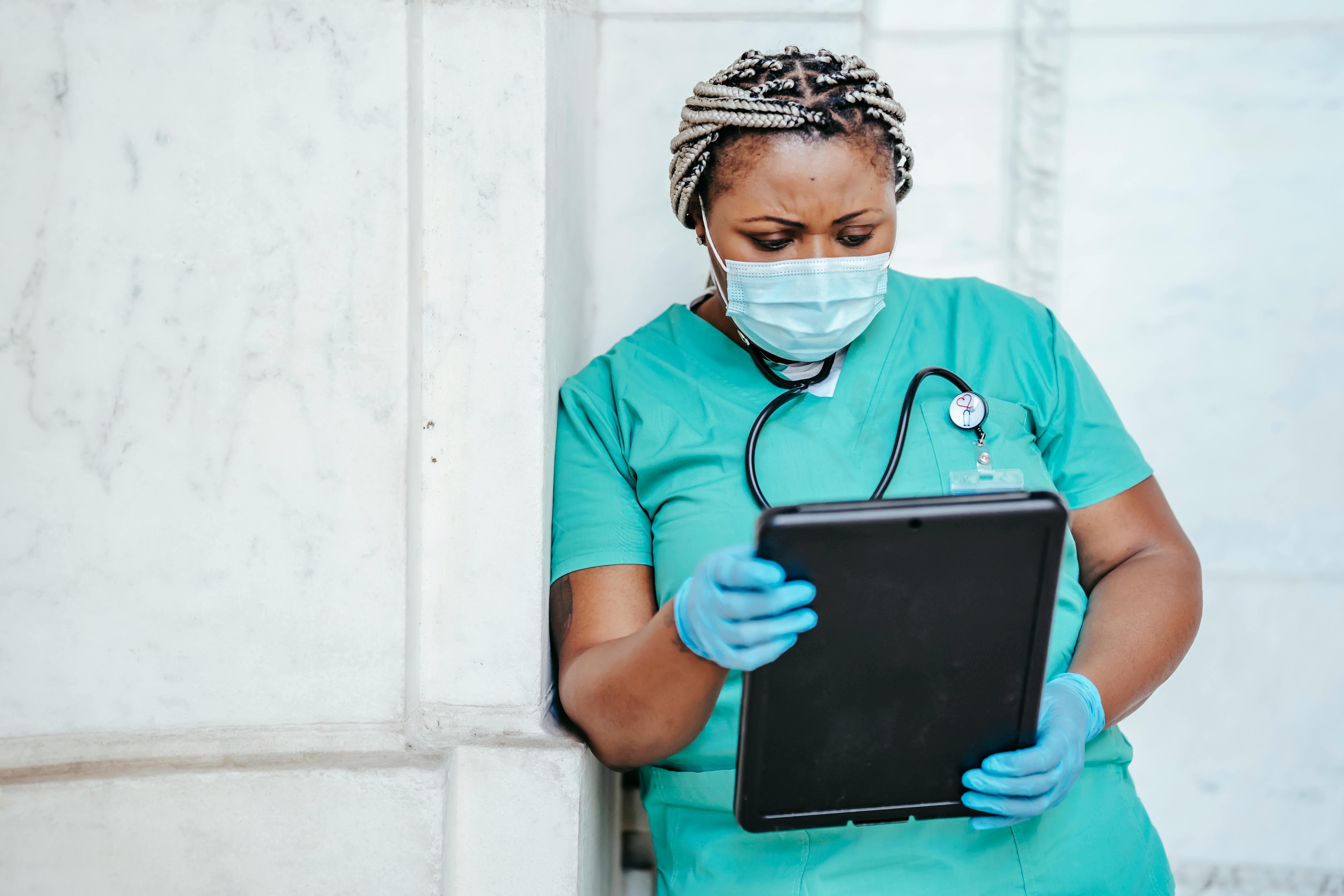 A doctor looking at her chart | Source: Pexels