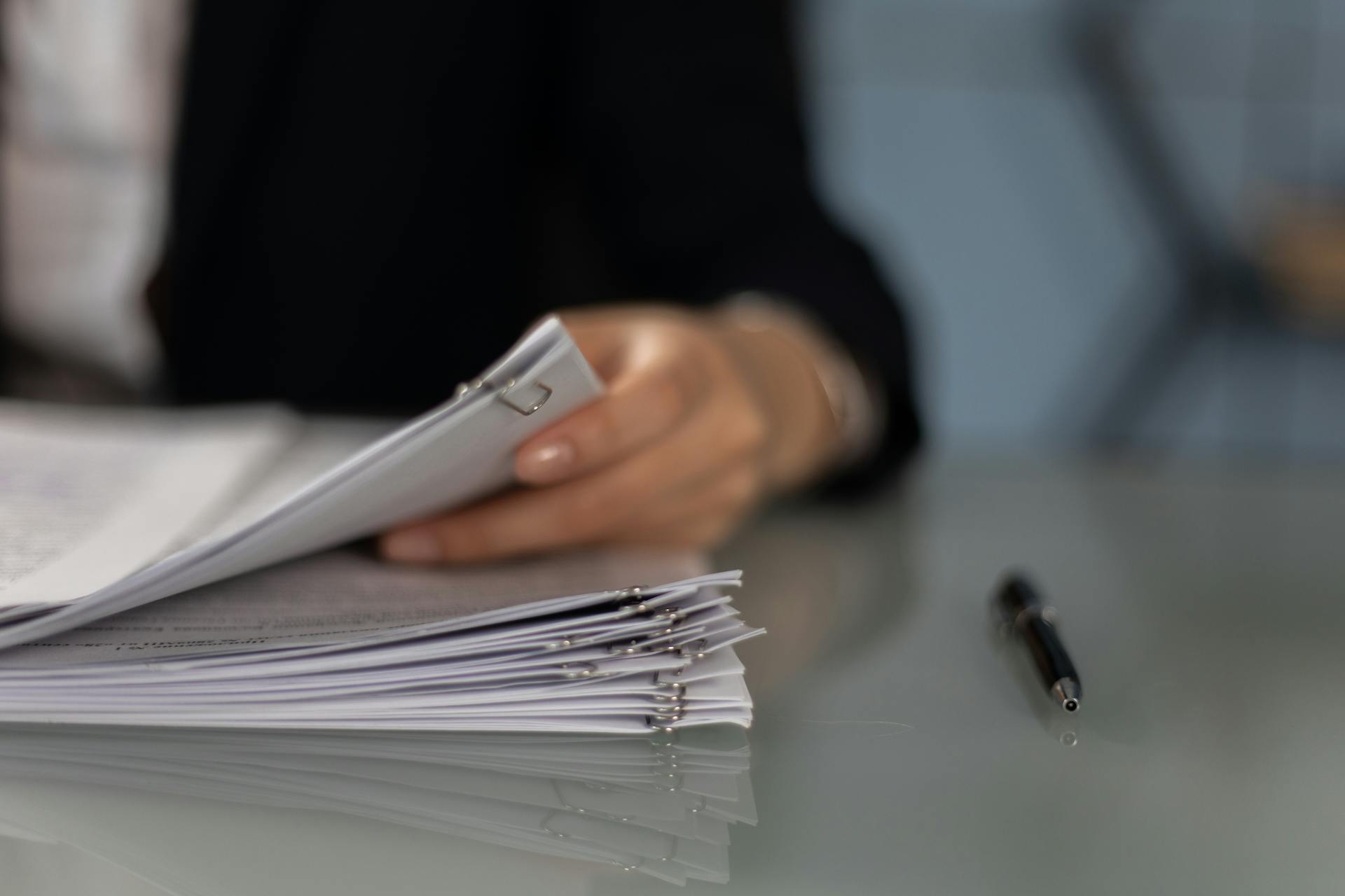 A woman holding documents | Source: Pexels