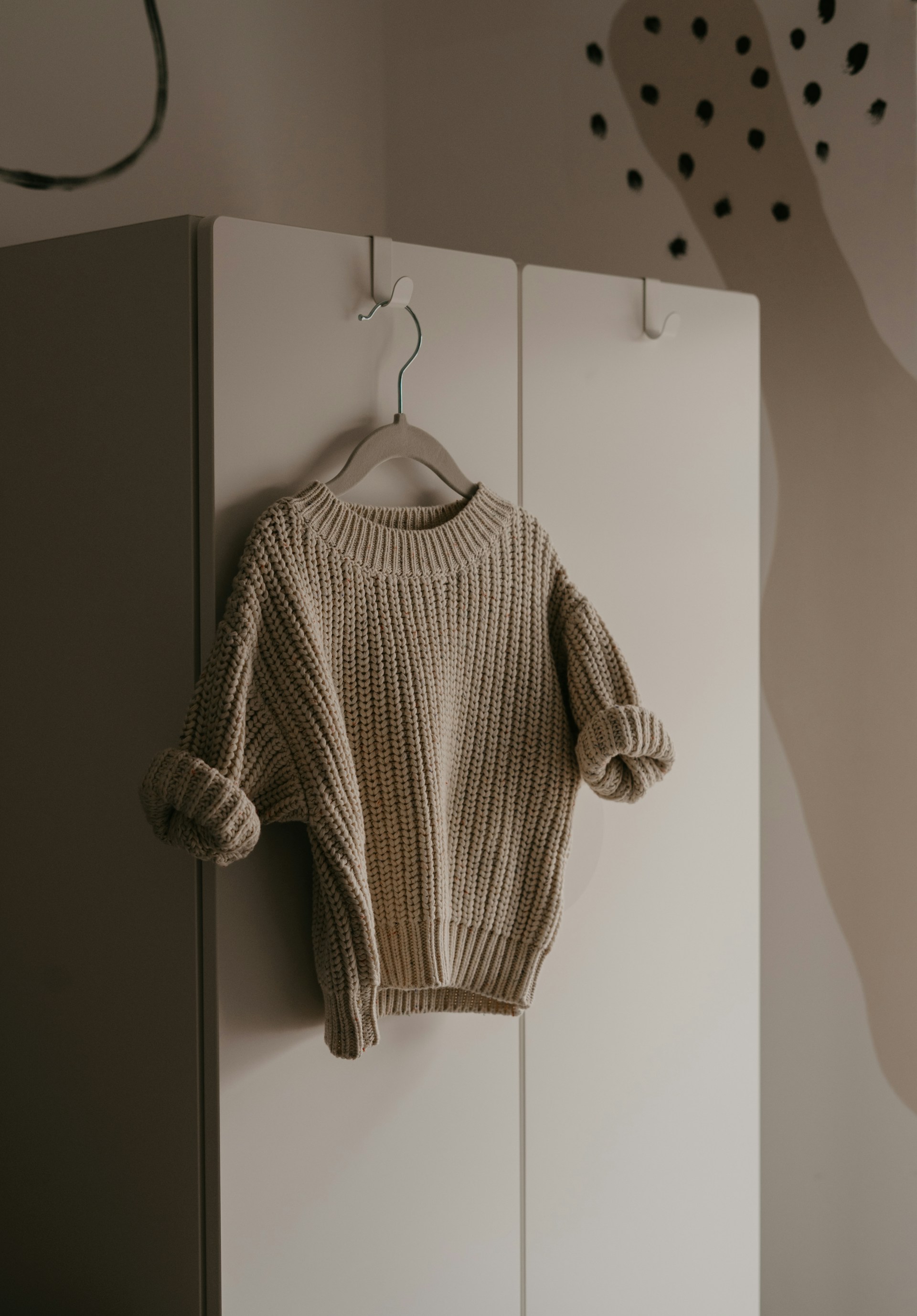 A sweater on a hanger | Source: Unsplash