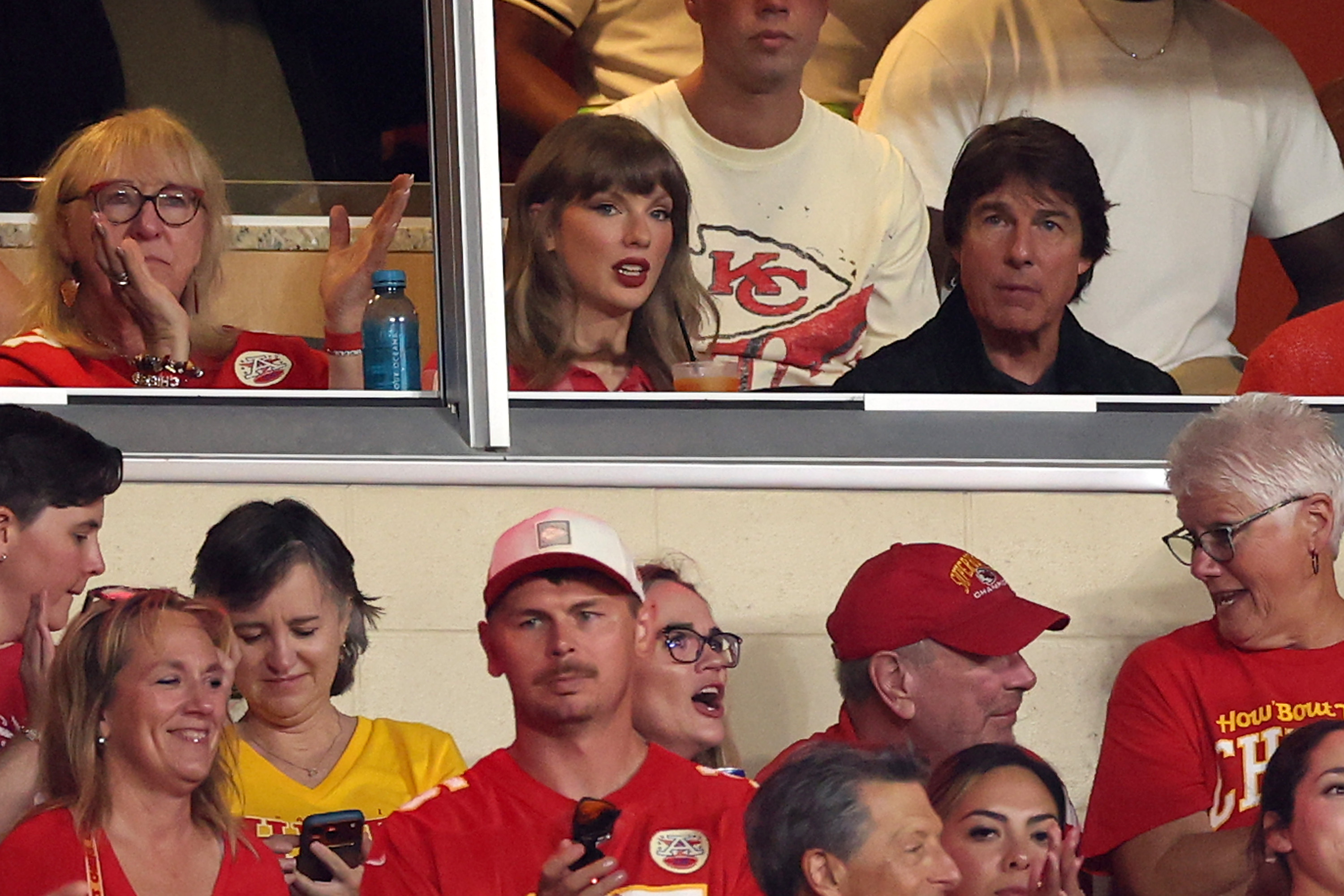 Taylor Swift watches the Kansas City Chiefs take on the Denver Broncos from a stadium suite alongside Tom Cruise at Arrowhead Stadium. | Source: Getty Images