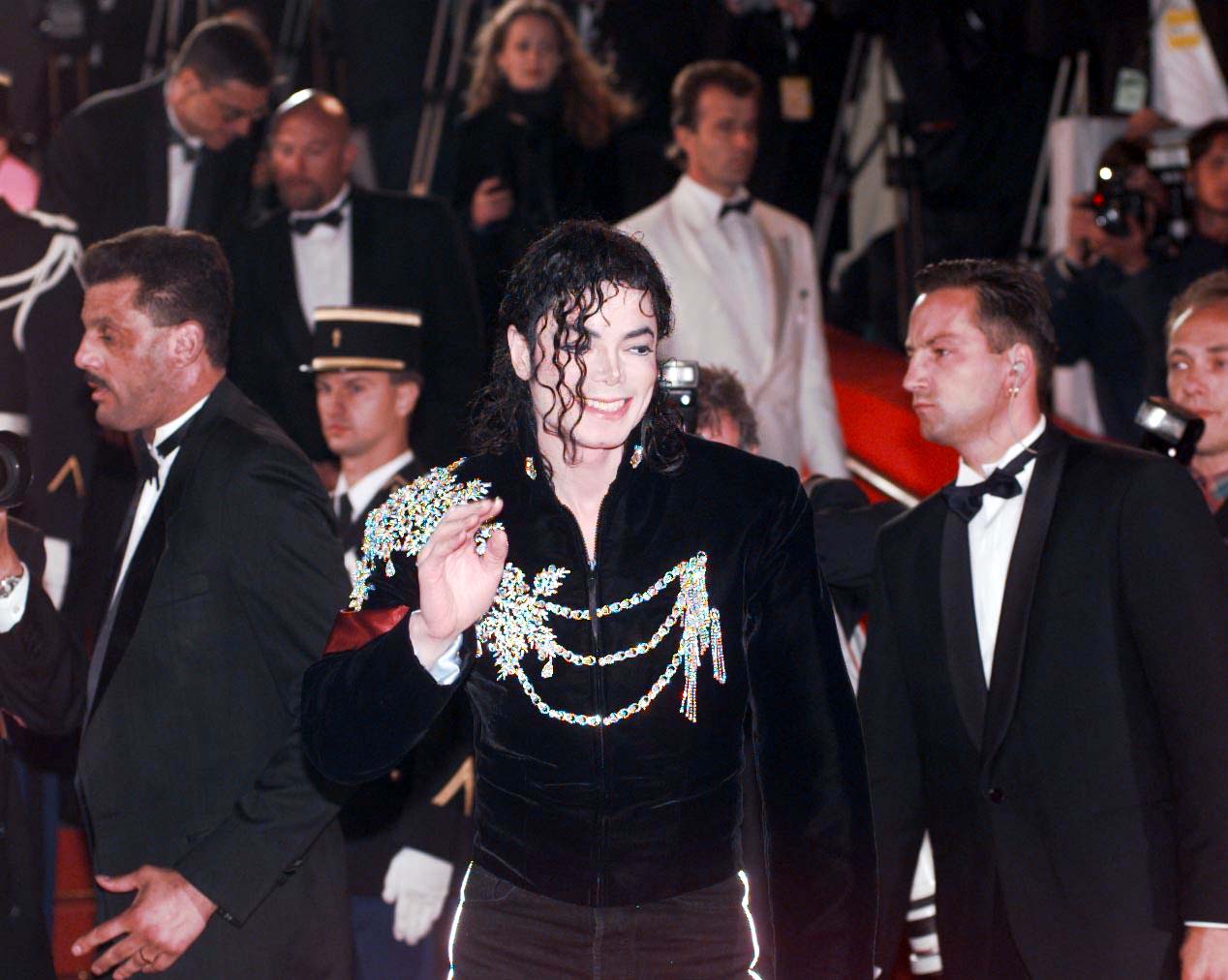 Michael Jackson waves to the crowd as he arrives for the screening of his new super-video Ghost, at the Cannes Film Festival on February 28, 2001. | Source: Getty Images