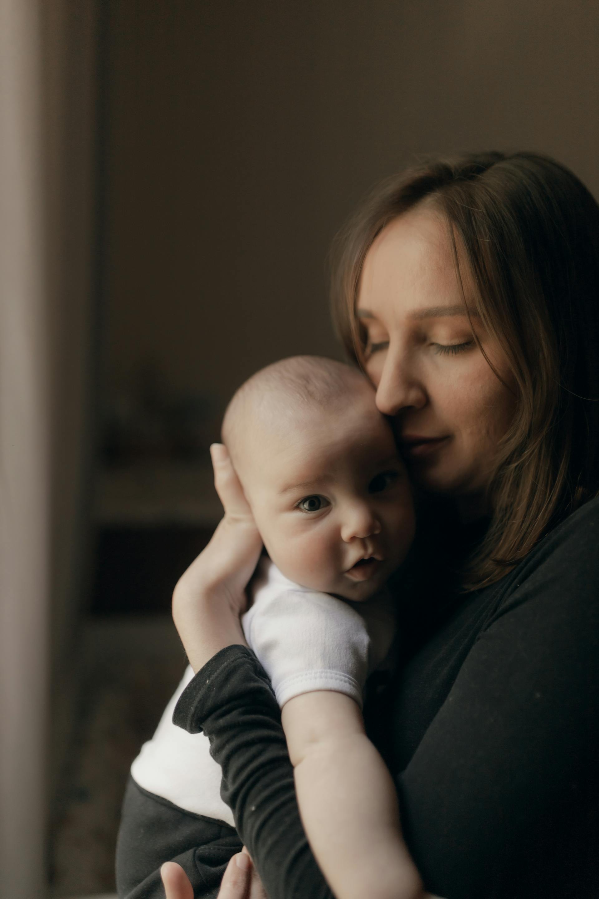 A woman holding a baby | Source: Pexels