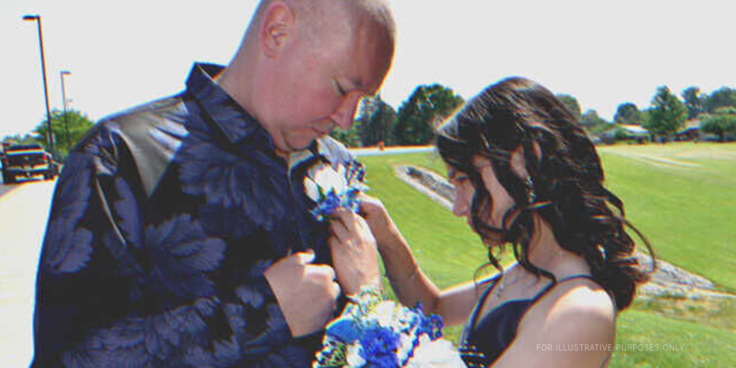 Young girl pinning flowers to an older man's shirt | Source: Shutterstock