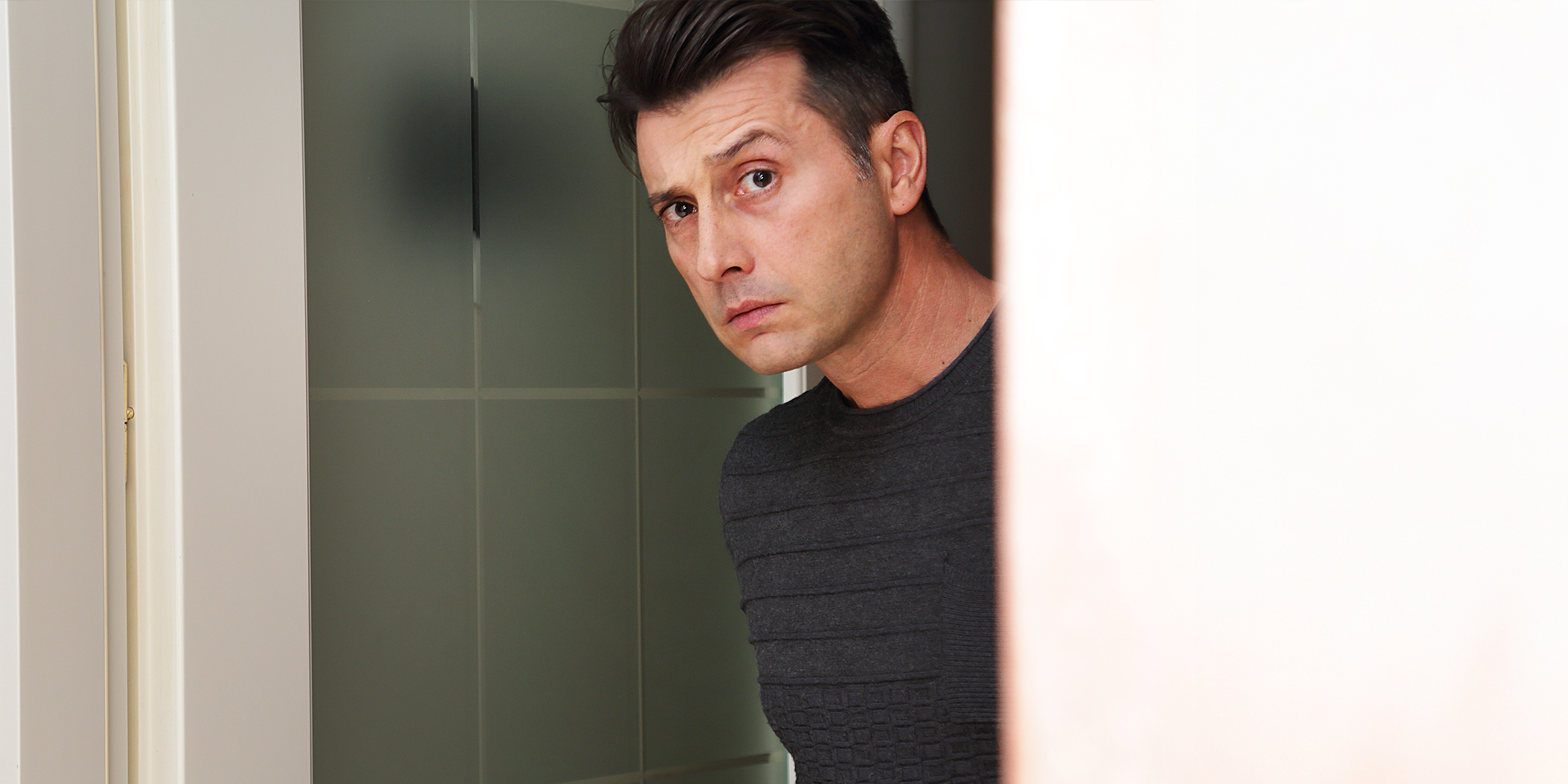 A man standing in his house | Source: Shutterstock