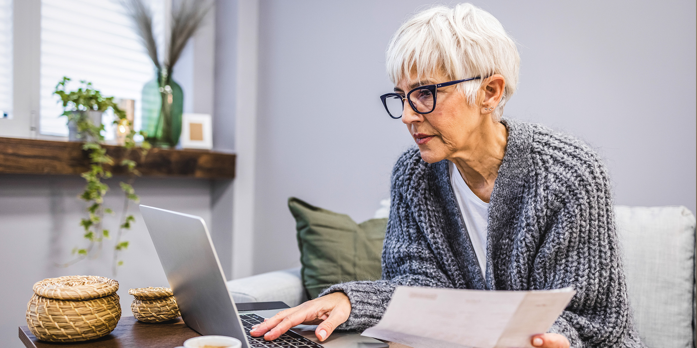 An older woman working on a laptop | Source: Shutterstock
