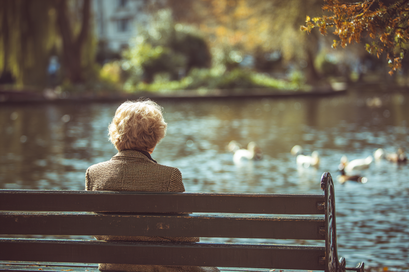 A woman sitting on a bench | Source: Midjourney