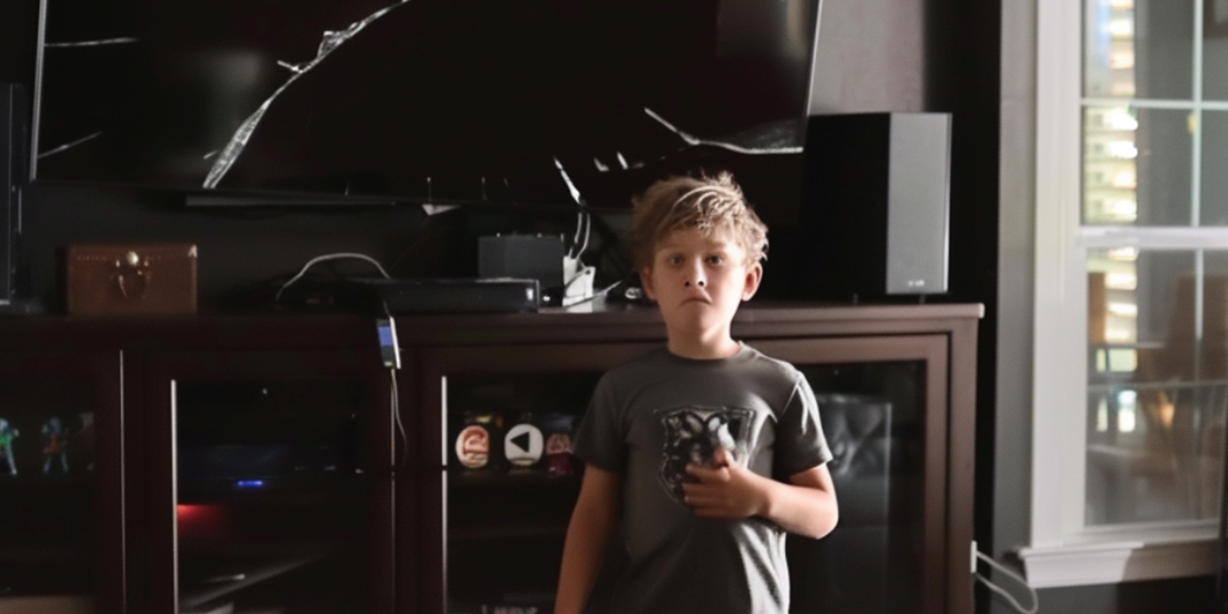 A startled boy and a broken TV in the backdrop | Source: AmoMama