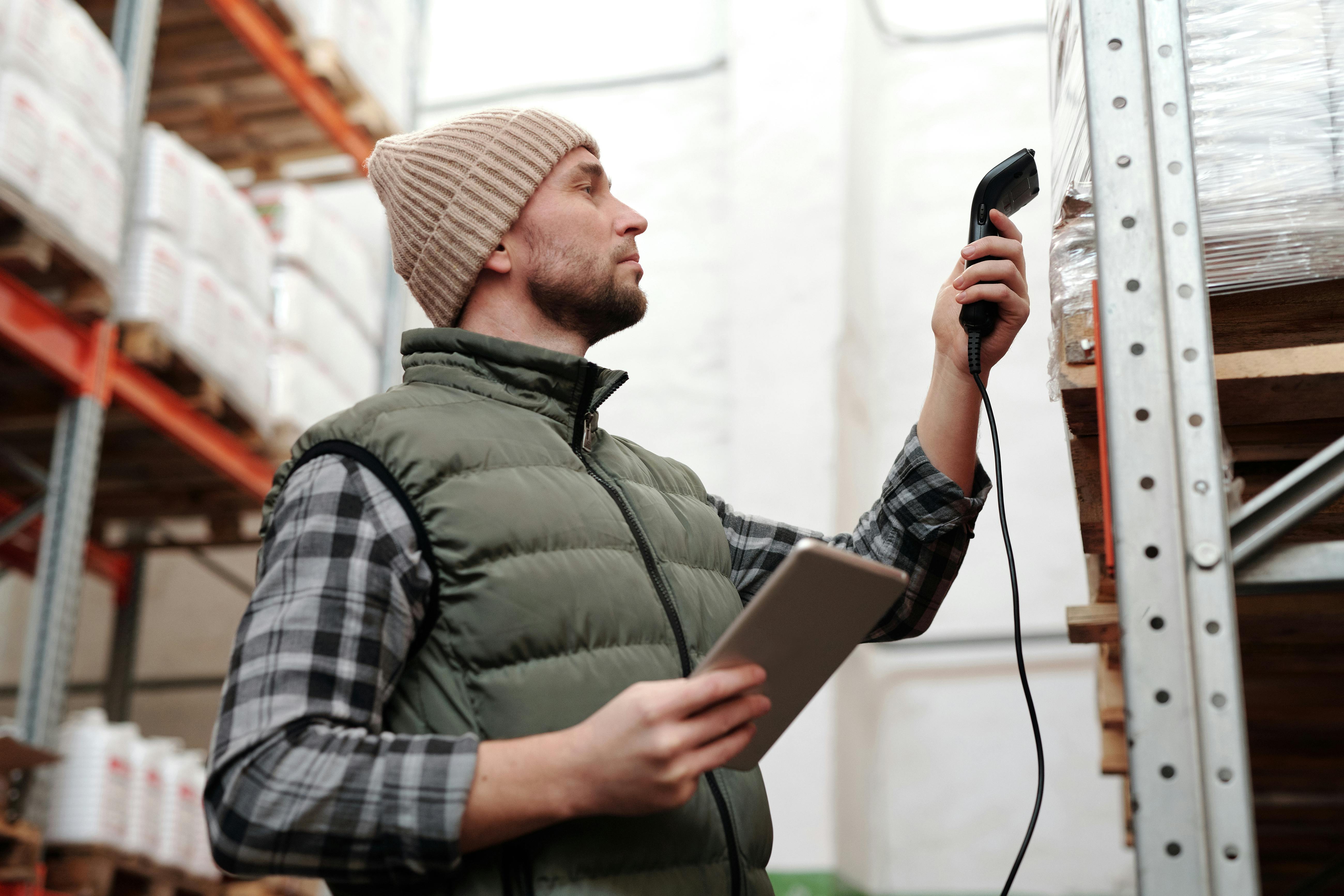 A man scanning products in a warehouse | Source: Pexels