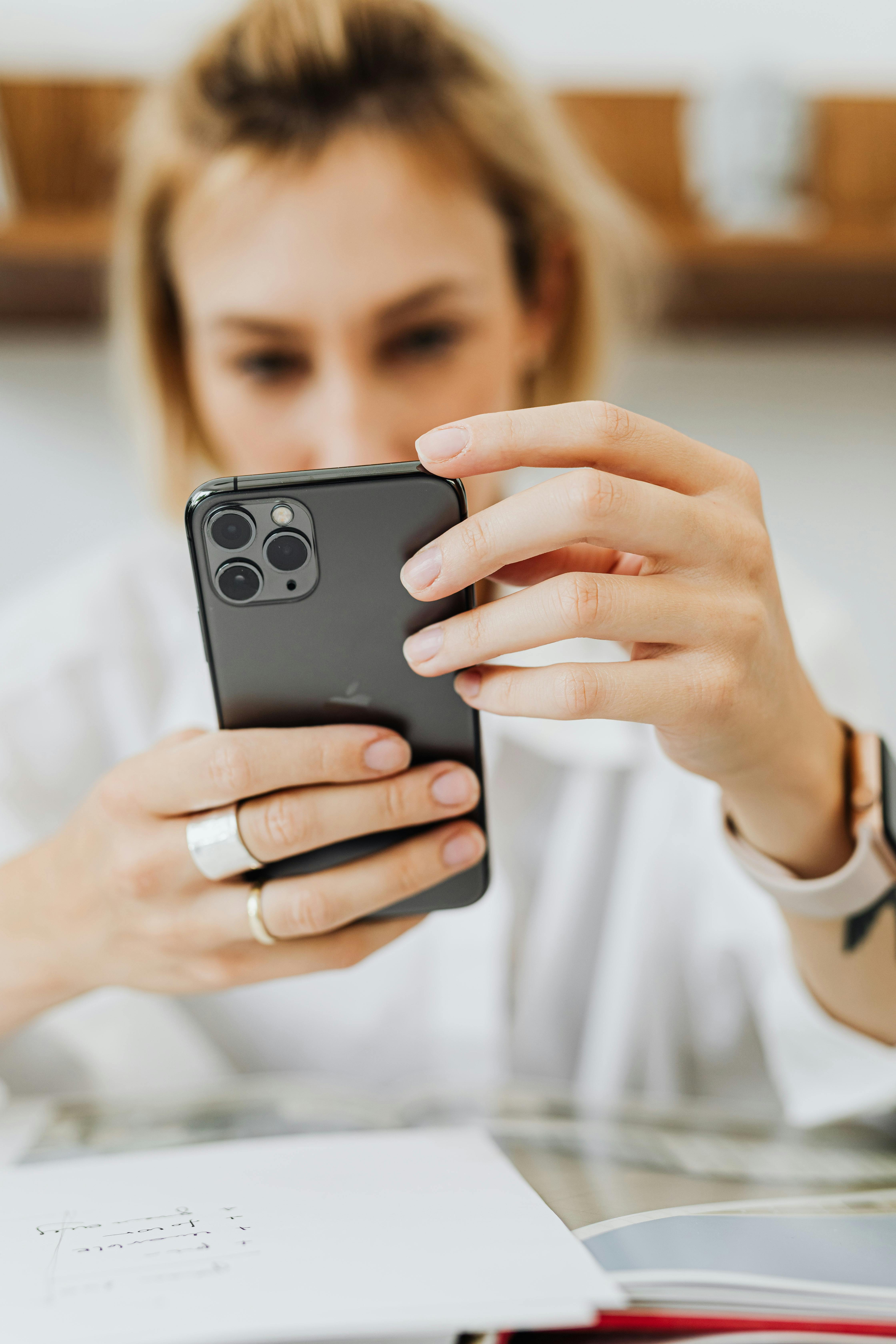 Woman looking at her phone | Source: Pexels