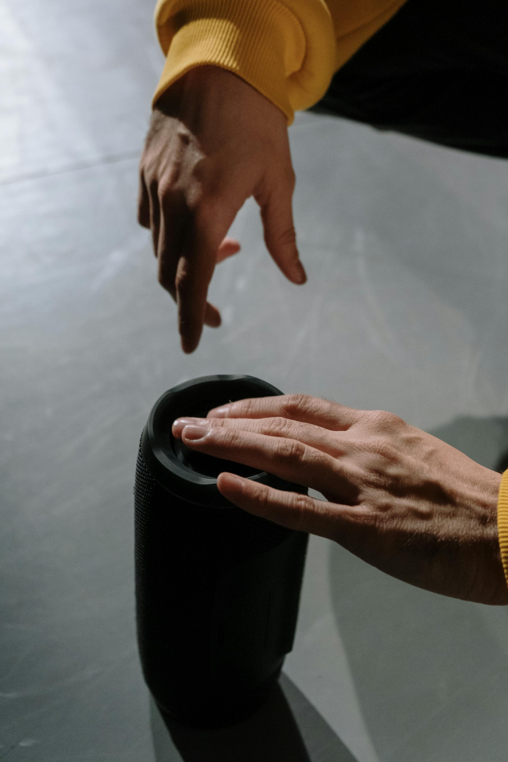 A person handling a Bluetooth speaker | Source: Pexels