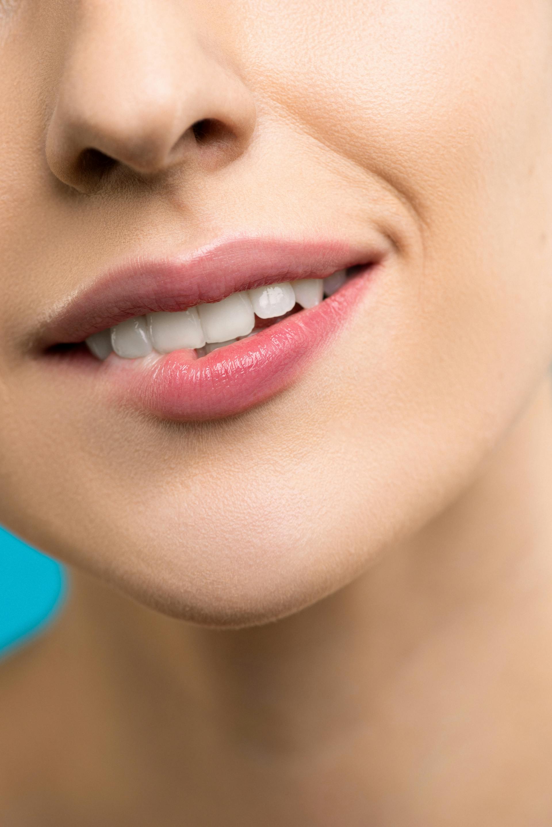 A woman smiling while biting her lip | Source: Pexels