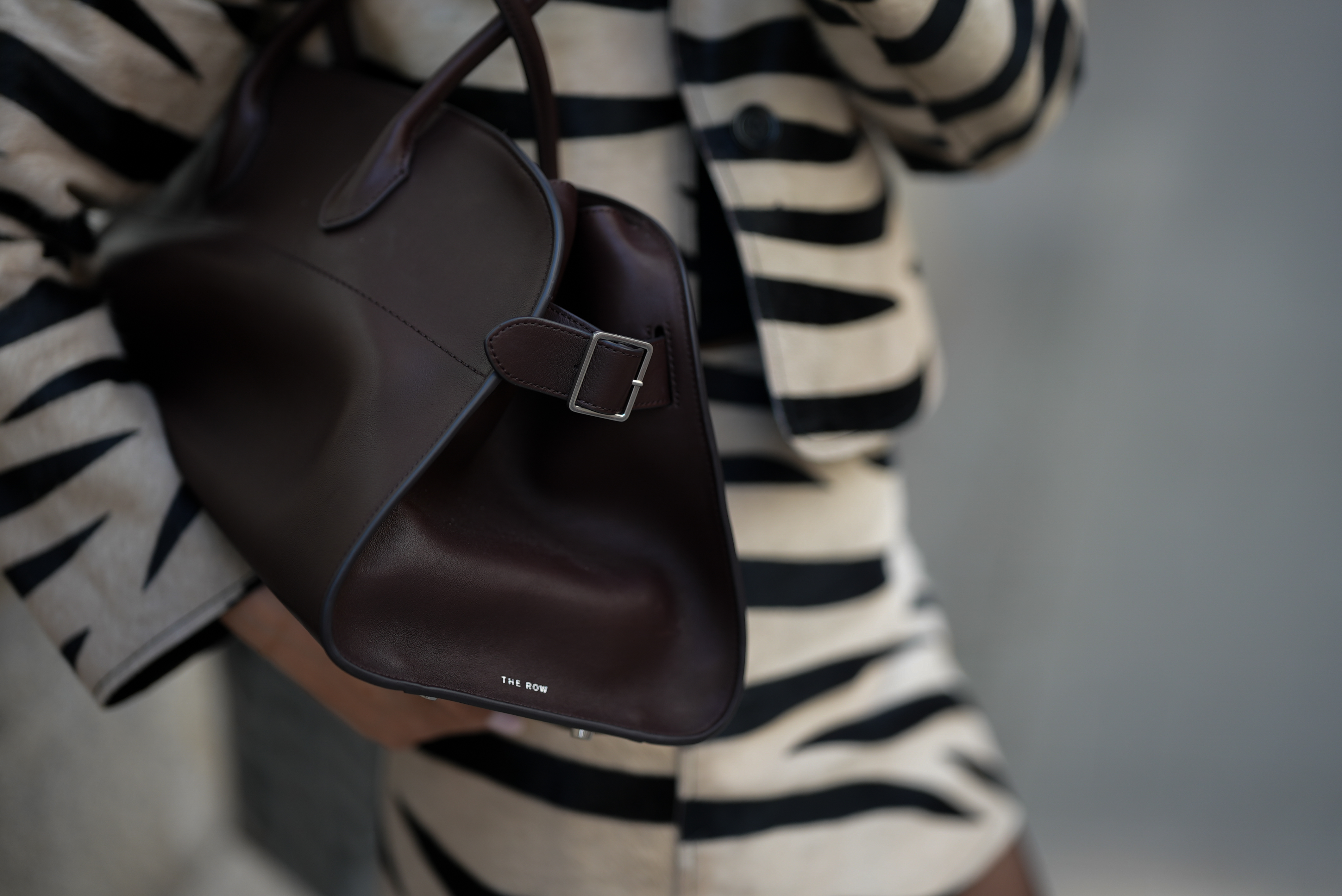 Milena Karl holding a dark brown Margaux bag from The Row on May 14, 2025 in Hamburg, Germany. | Source: Getty Images
