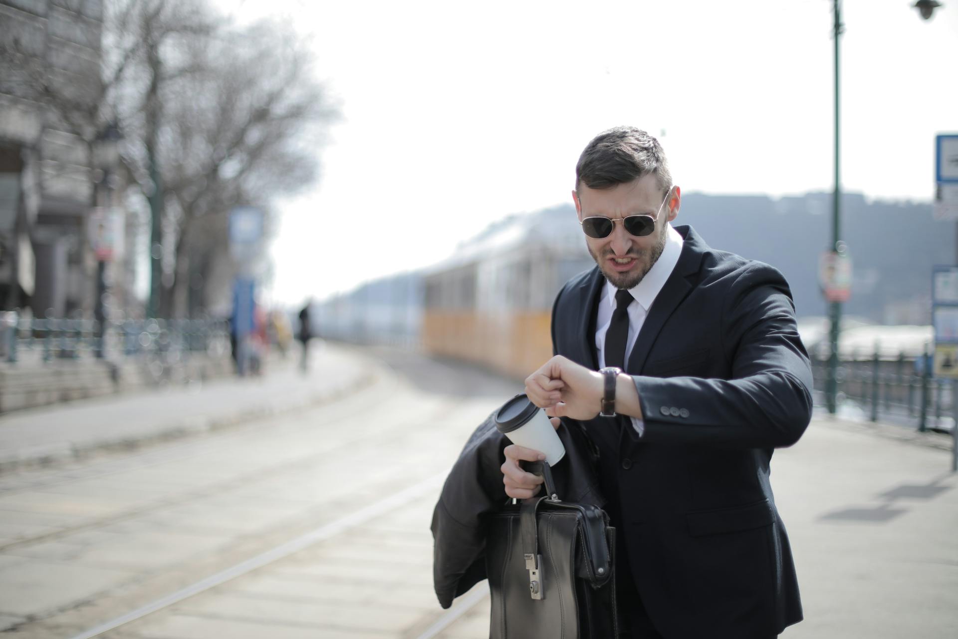 A distraught man looking at his watch | Source: Pexels