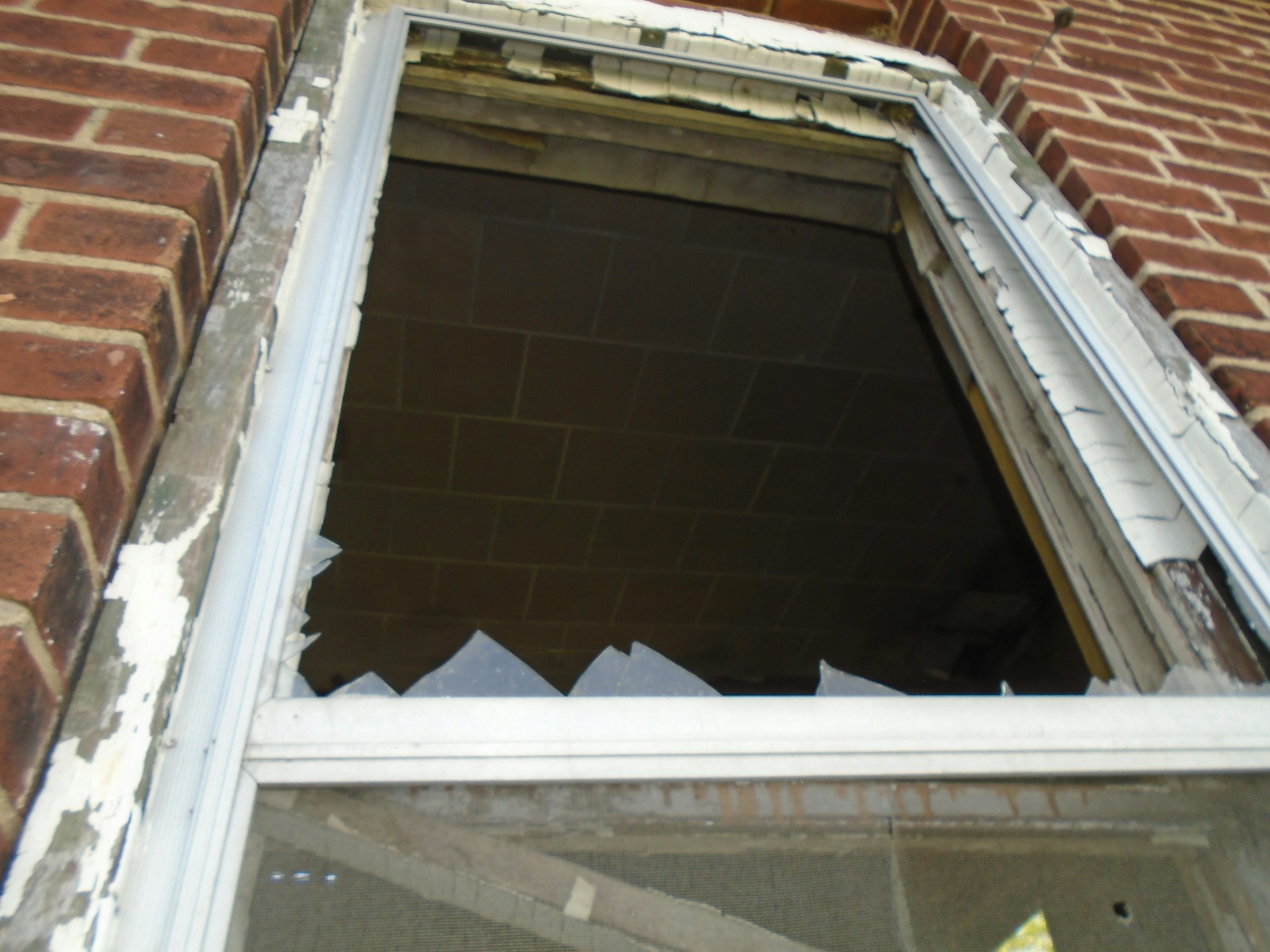 Close-up shot of a broken window | Source: Unsplash