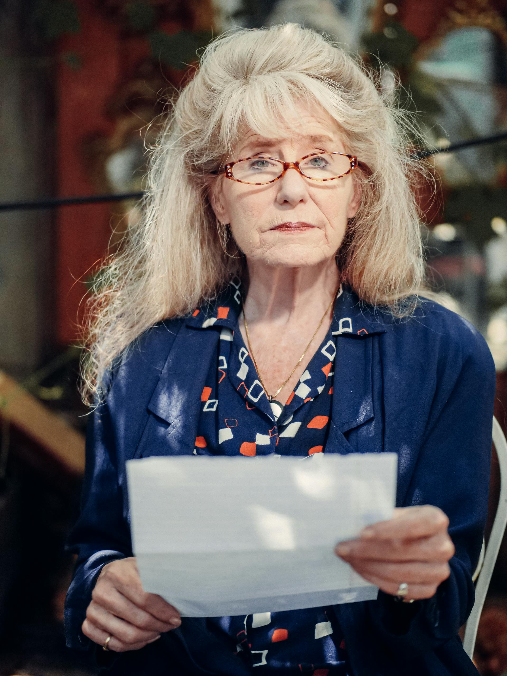 A woman holding a piece of paper | Source: Pexels