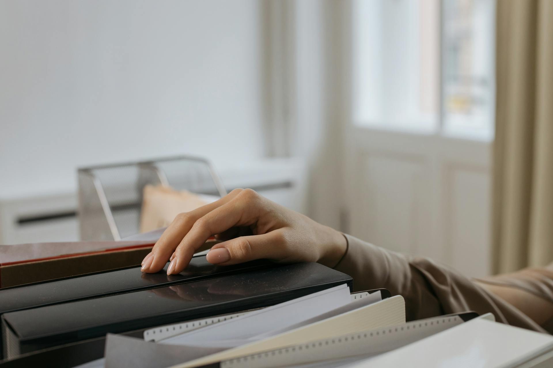 A woman reaching for a file | Source: Pexels