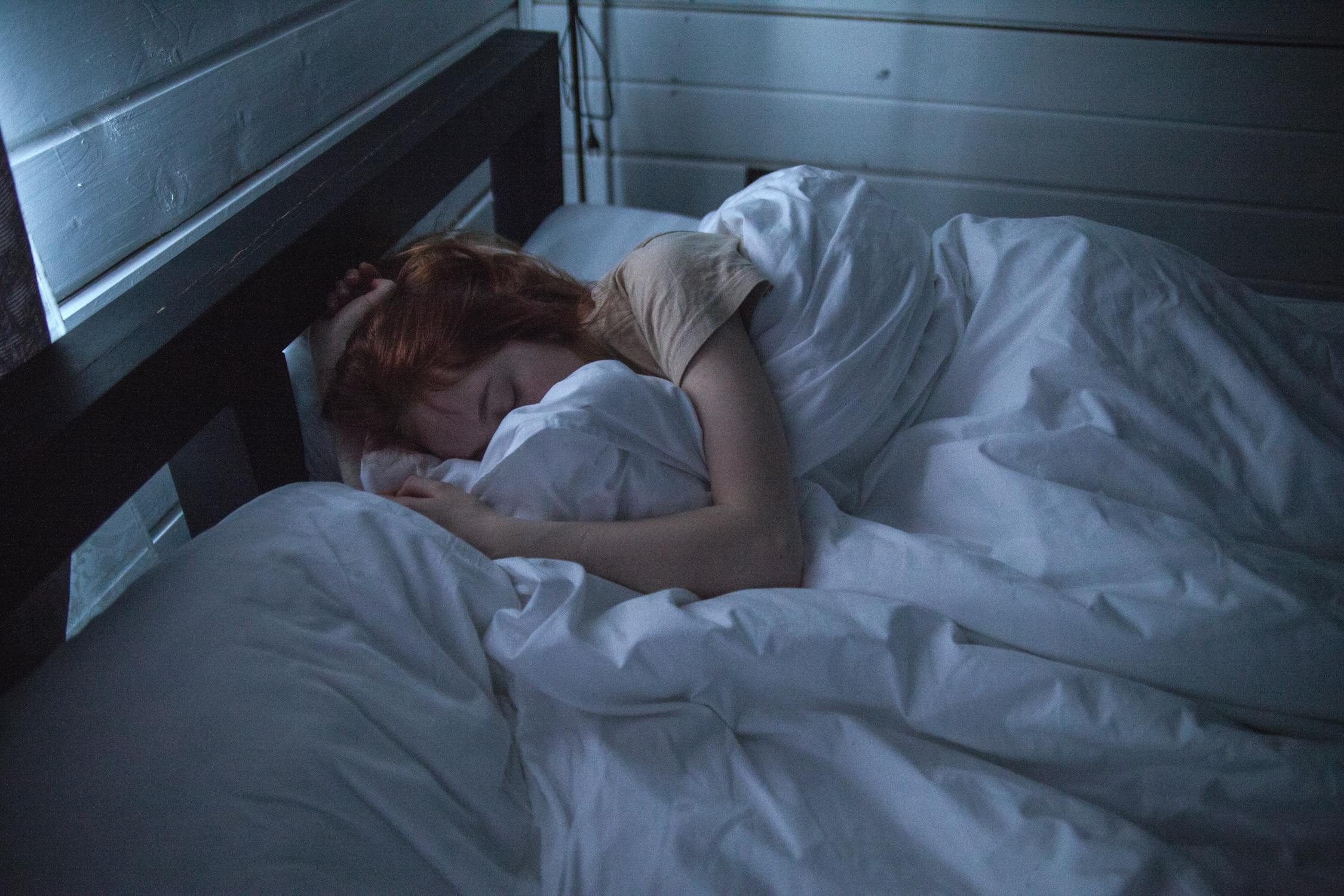 A woman sleeping in her bed | Source: Pexels