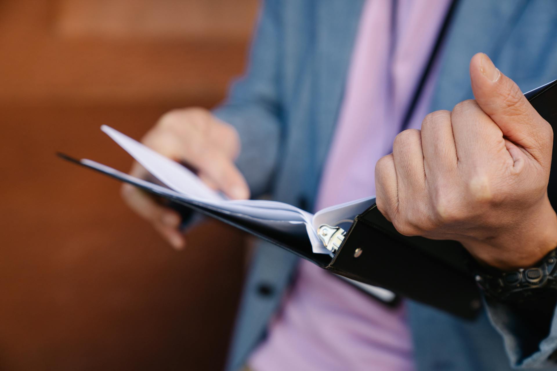 A person holding a folder | Source: Pexels