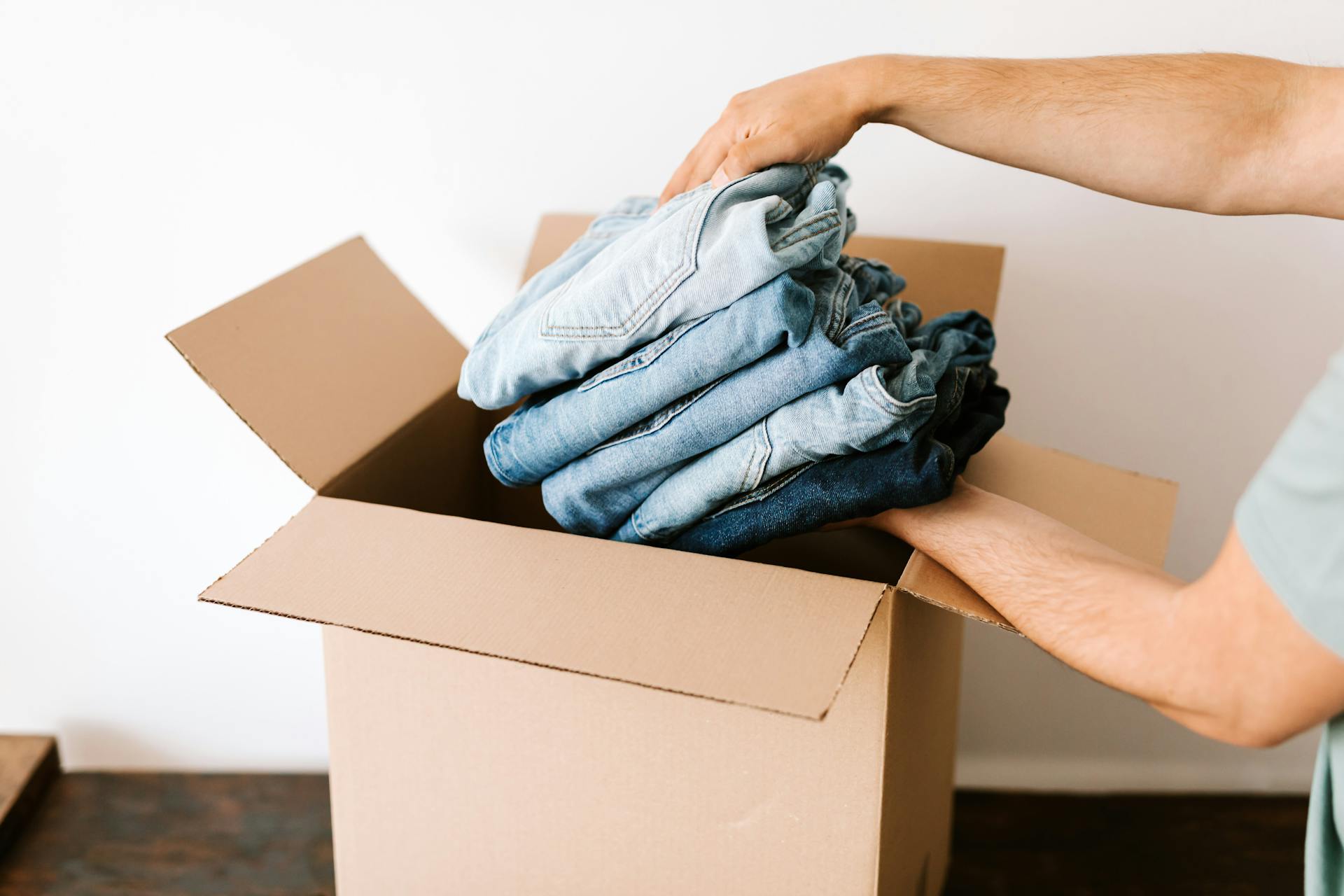 A person taking out clothes from a box | Source: Pexels