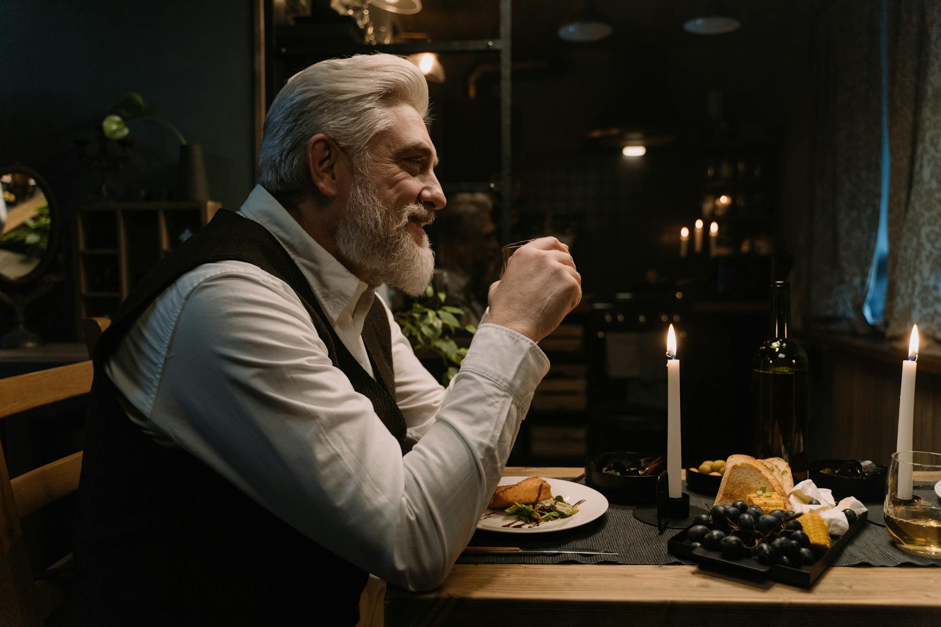 A senior man sitting in a posh dining room and smiling | Source: Pexels