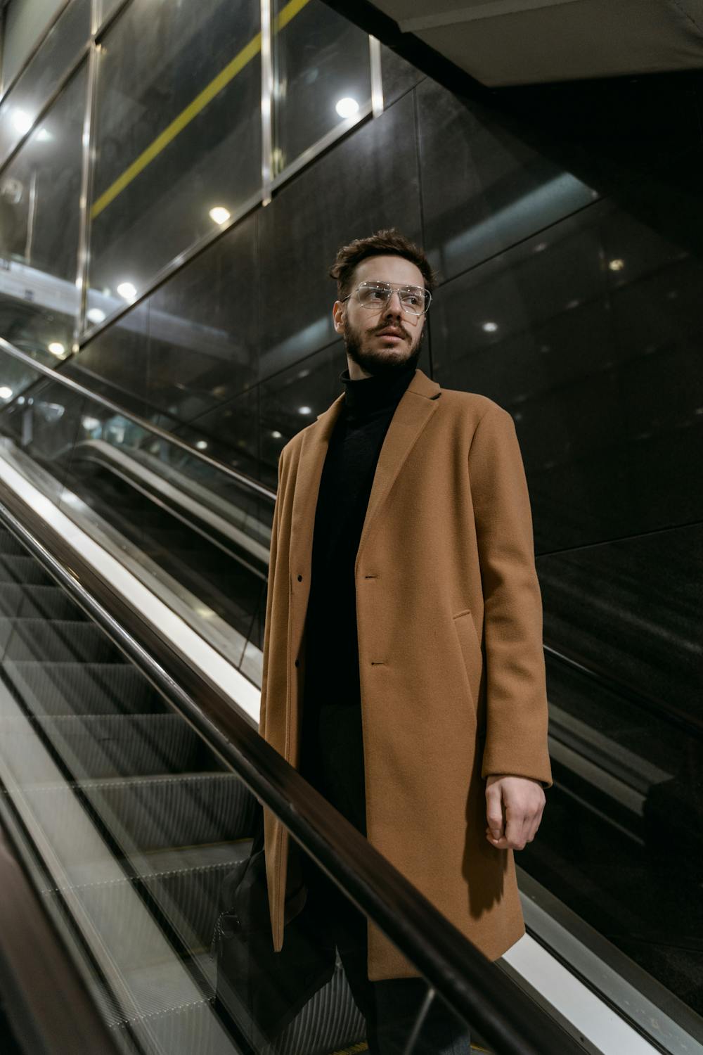 A man riding an escalator in a mall | Source: Pexels