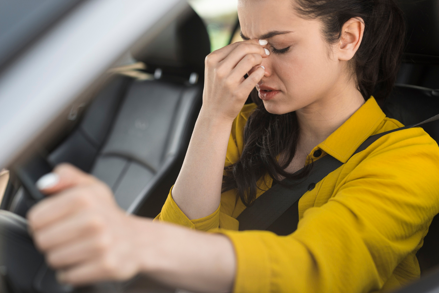 A depressed woman sitting in the car | Source: Freepik