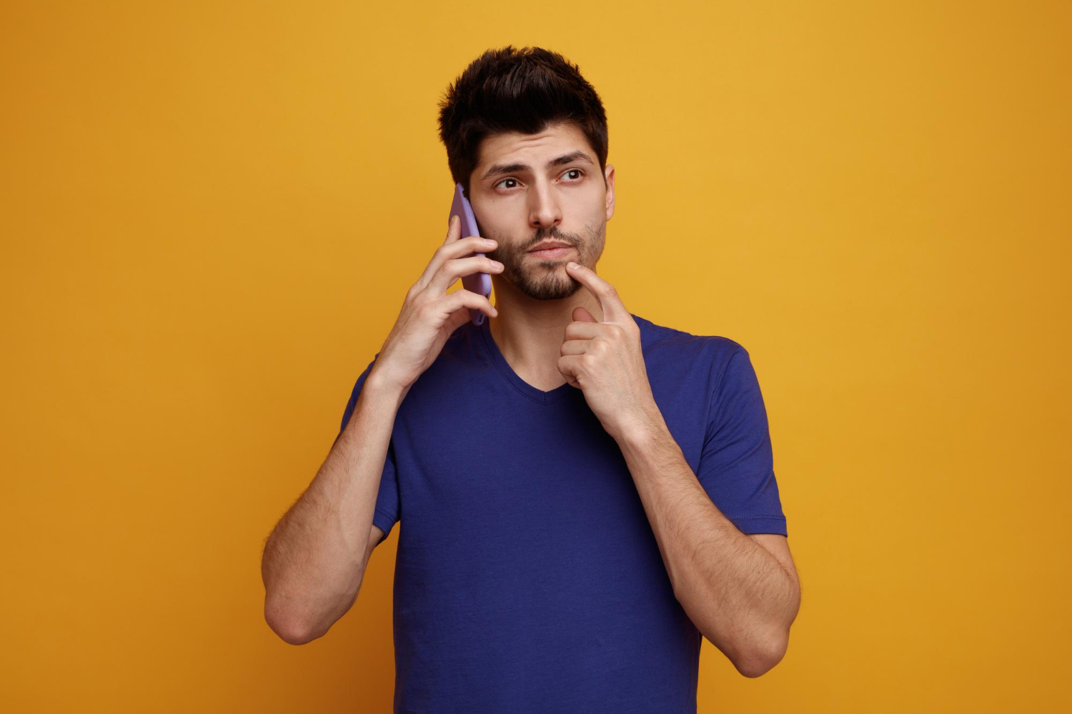 A thoughtful man talking on the phone | Source: Freepik