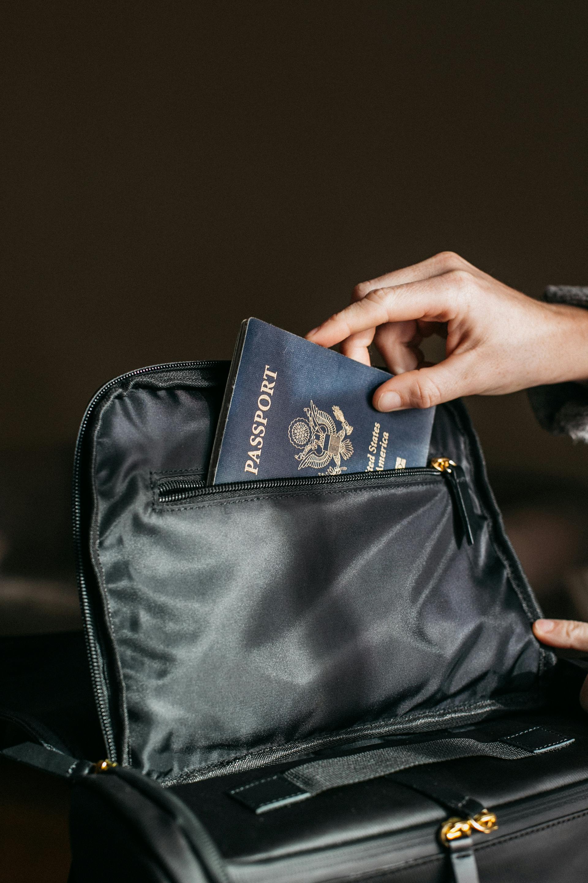 A person taking a passport out of a bag | Source: Pexels