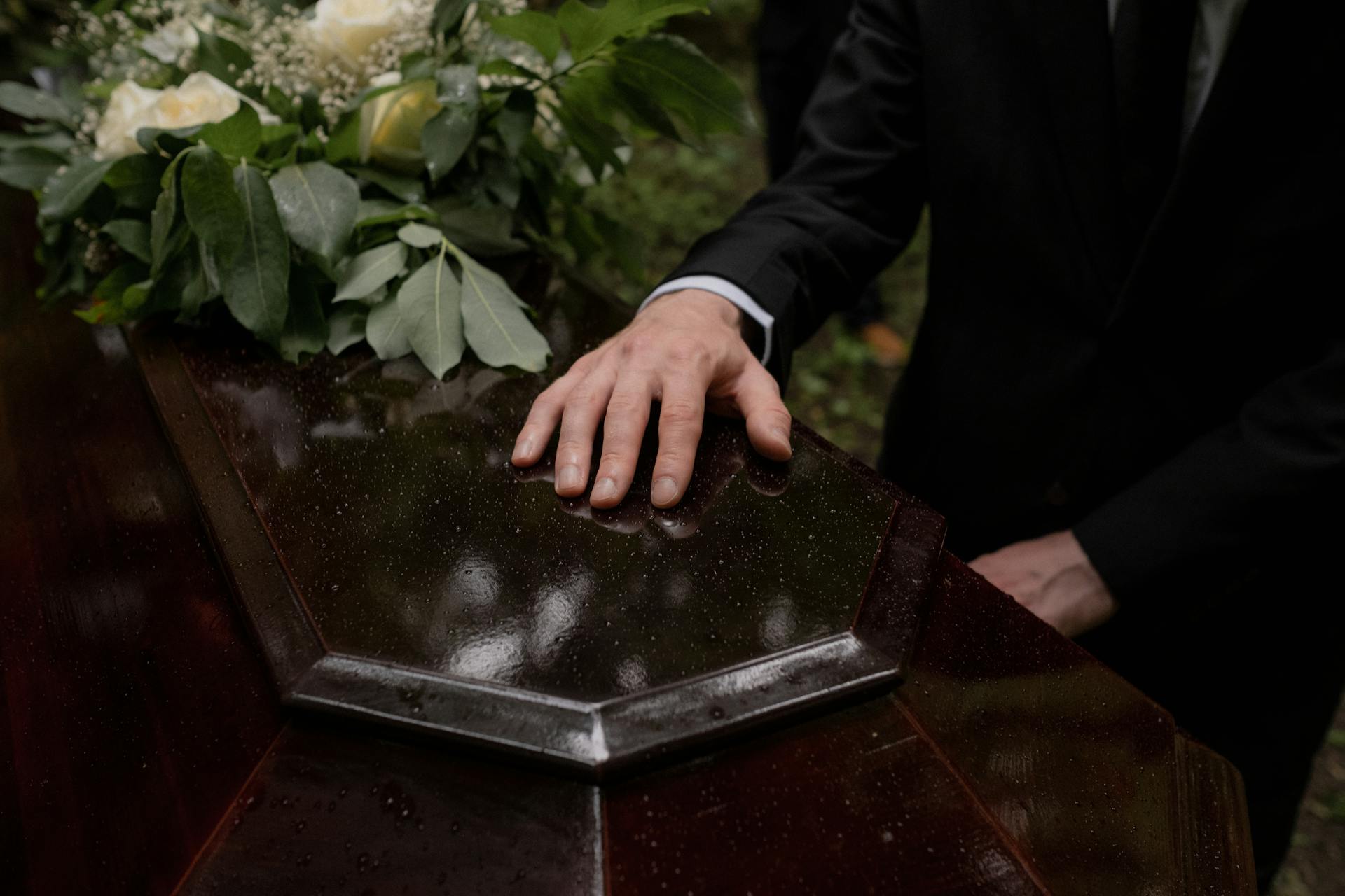 A man touching a coffin | Source: Pexels