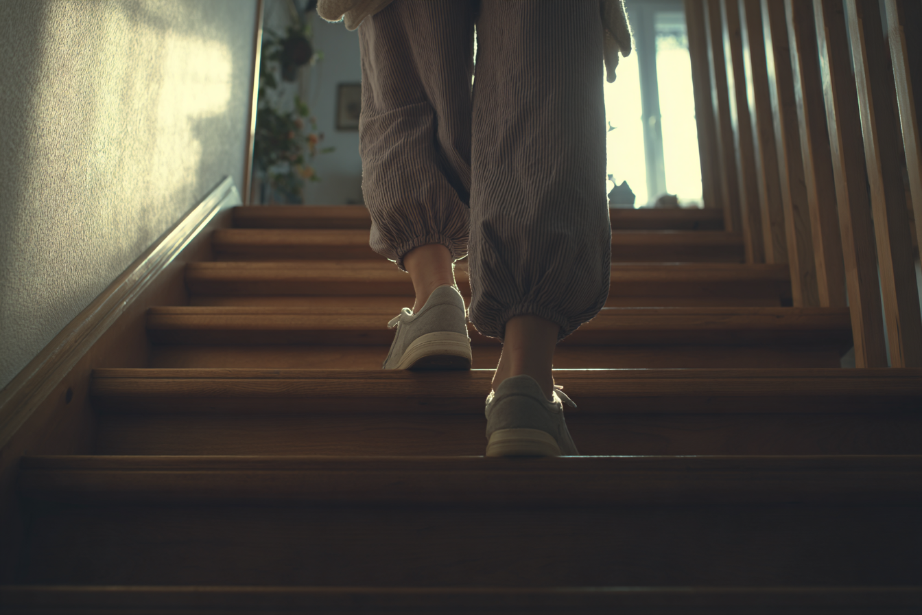 A woman going up the stairs | Source: Midjourney