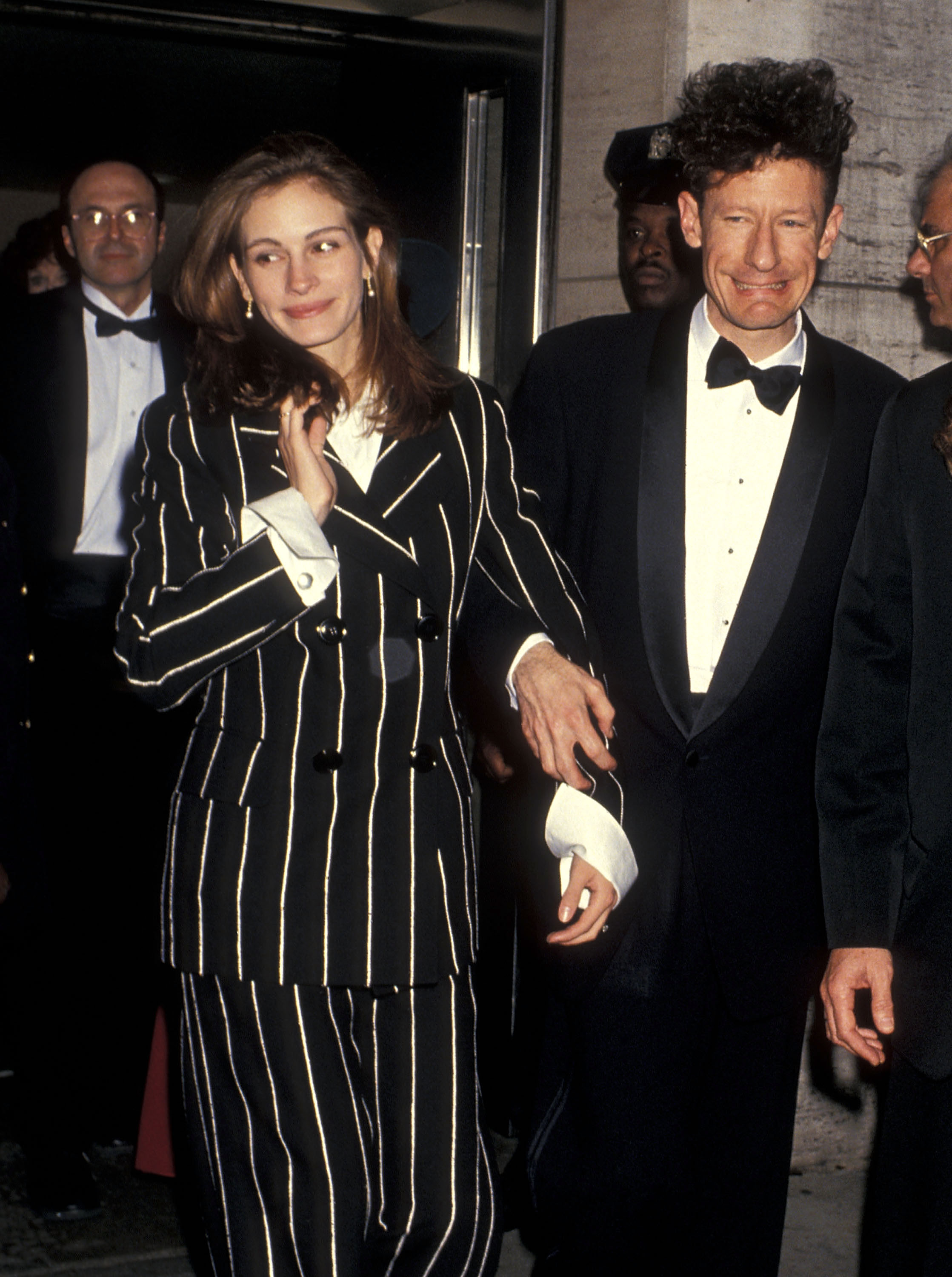 Julia Roberts wears a black-and-white striped pantsuit while walking with Lyle Lovett at the 31st Annual New York Film Festival opening night screening of "Short Cuts" on October 1, 1993, at Avery Fisher Hall at Lincoln Center in New York City.
