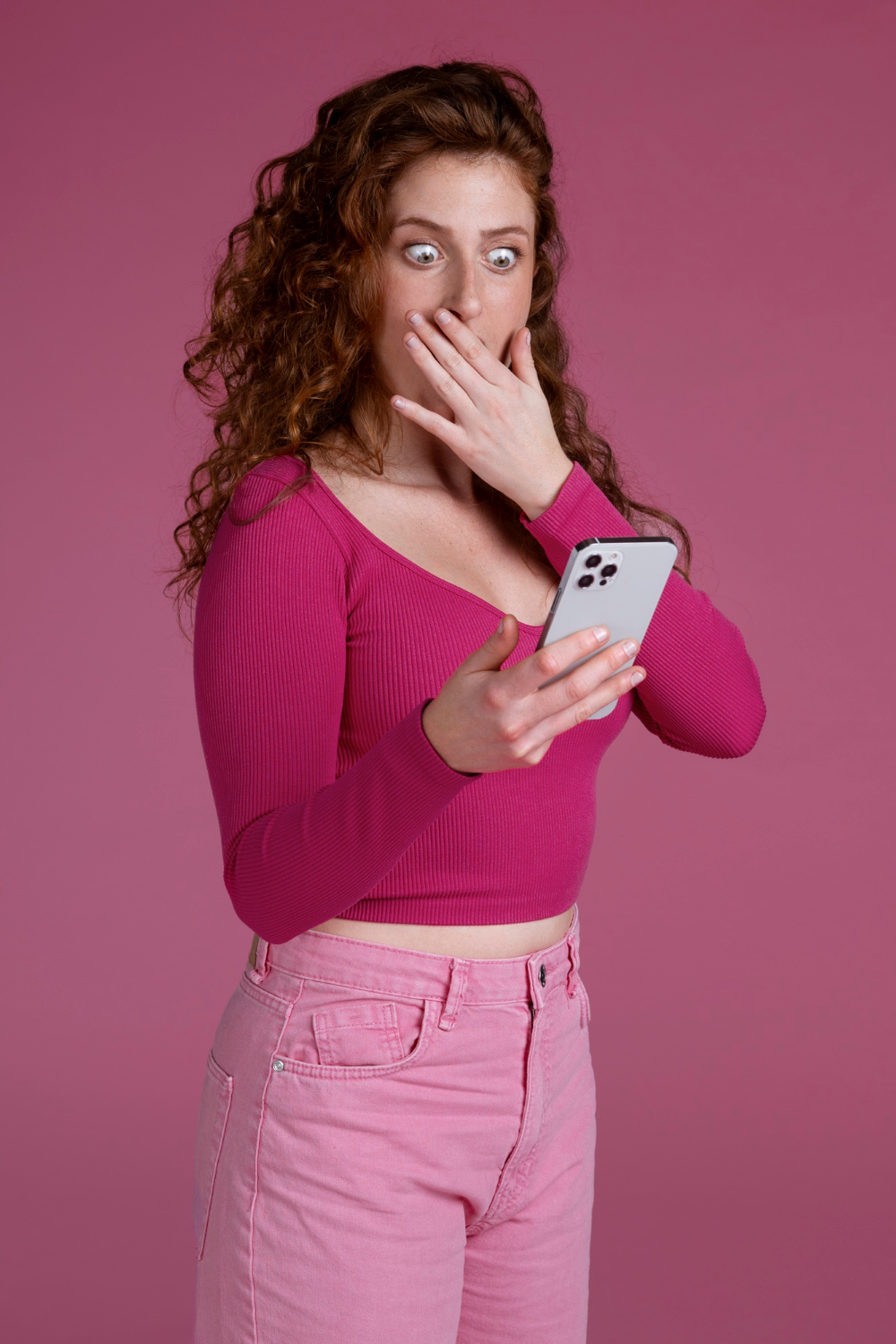 A shaken woman looking at her phone | Source: Freepik