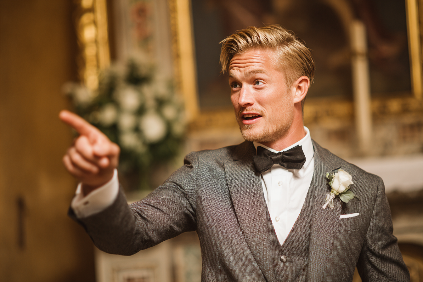 A groomsman pointing at something | Source: Midjourney