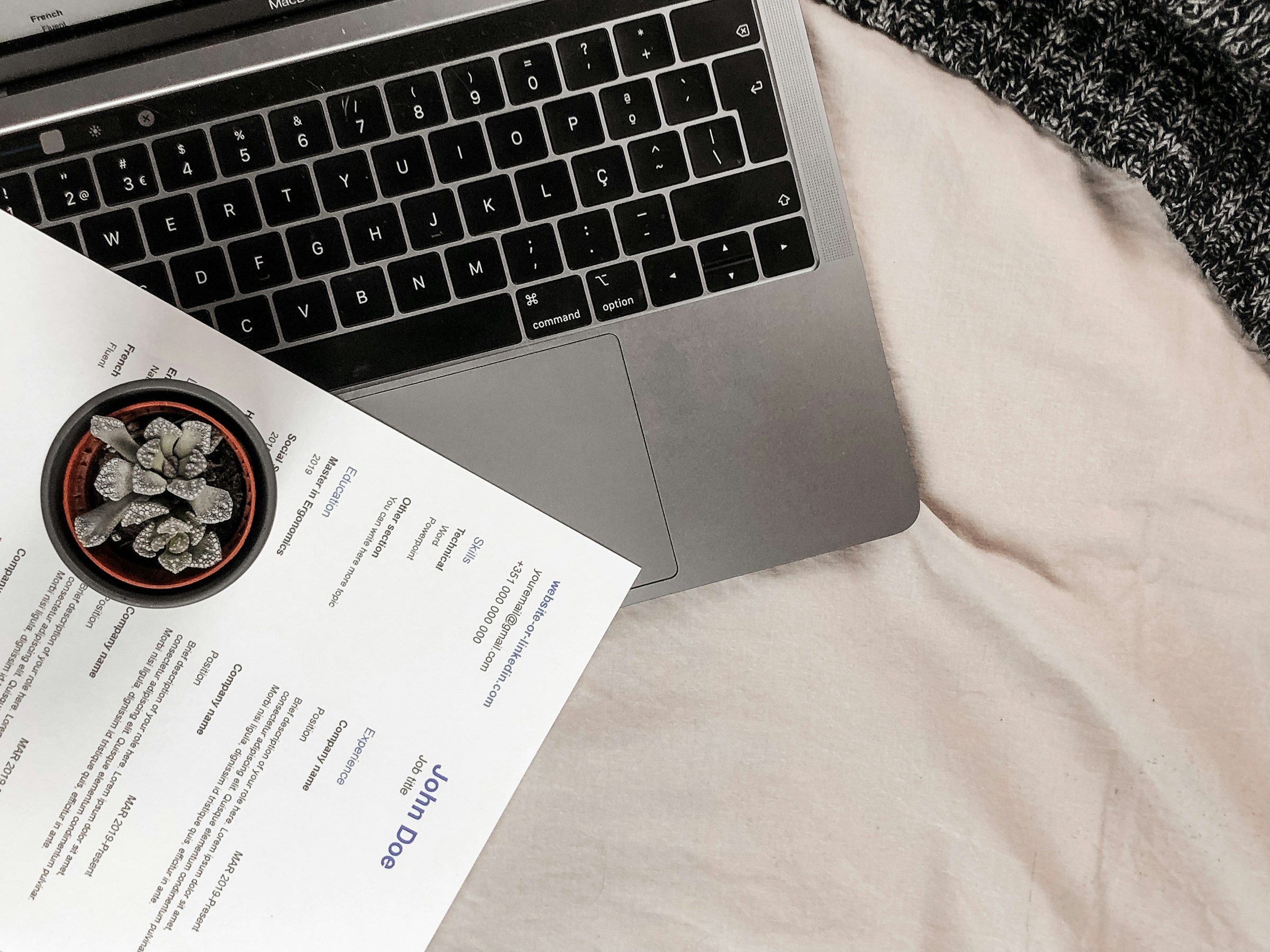 A resume lying on a laptop | Source: Unsplash