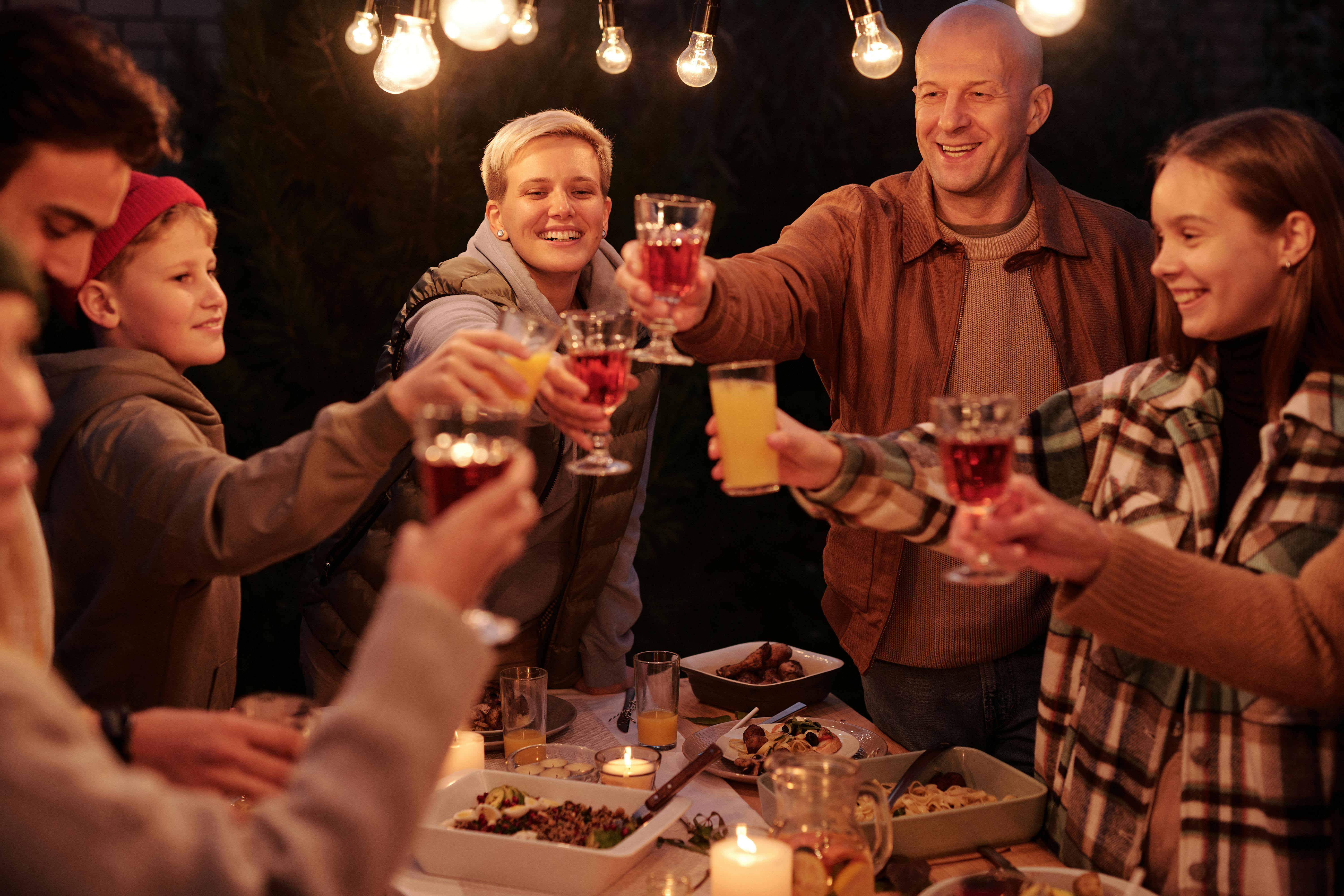 A family toasting under lights | Source: Pexels