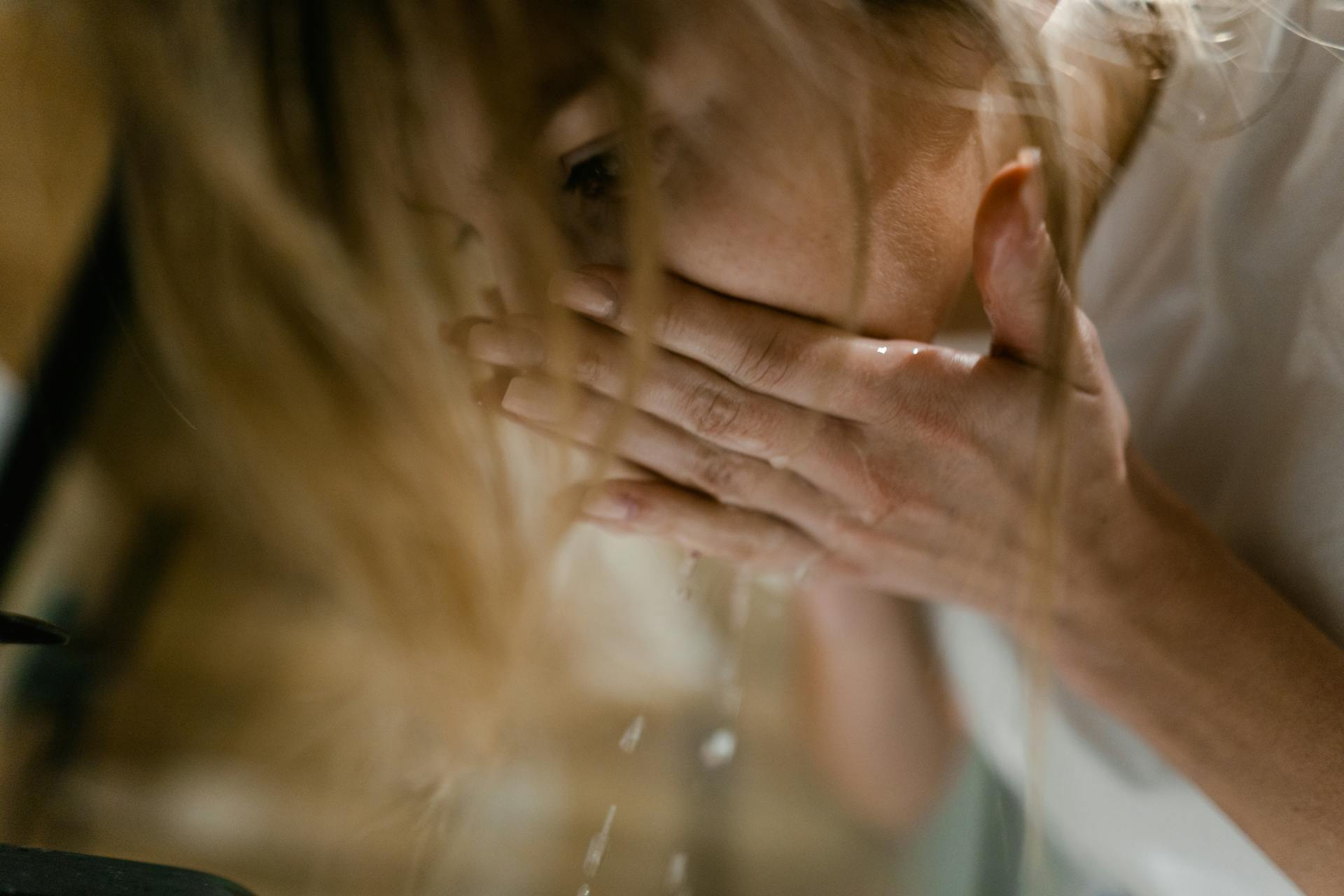 A close-up shot of a woman washing her face | Source: Pexels