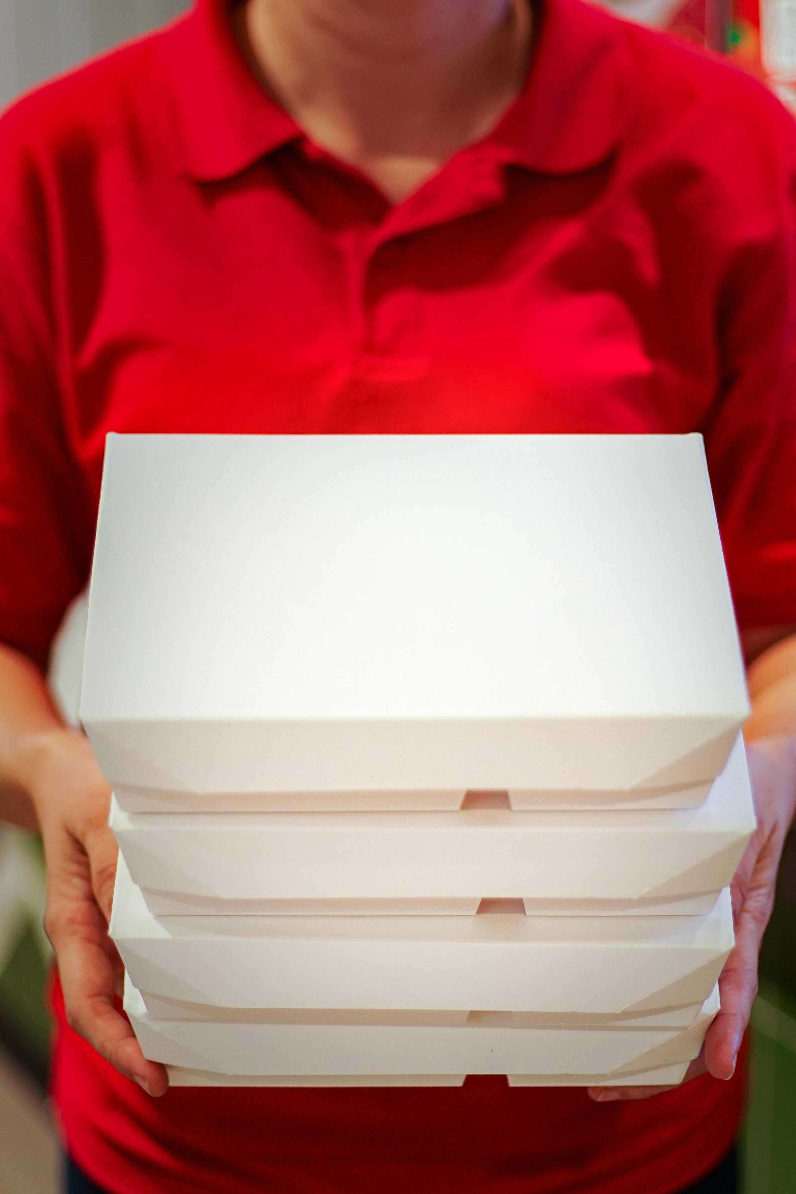 Someone holding takeout containers | Source: Pexels