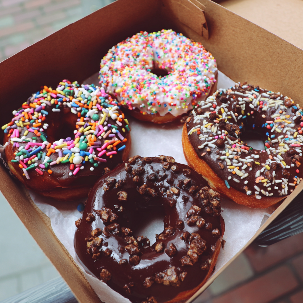 A box of chocolate donuts | Source: Midjourney