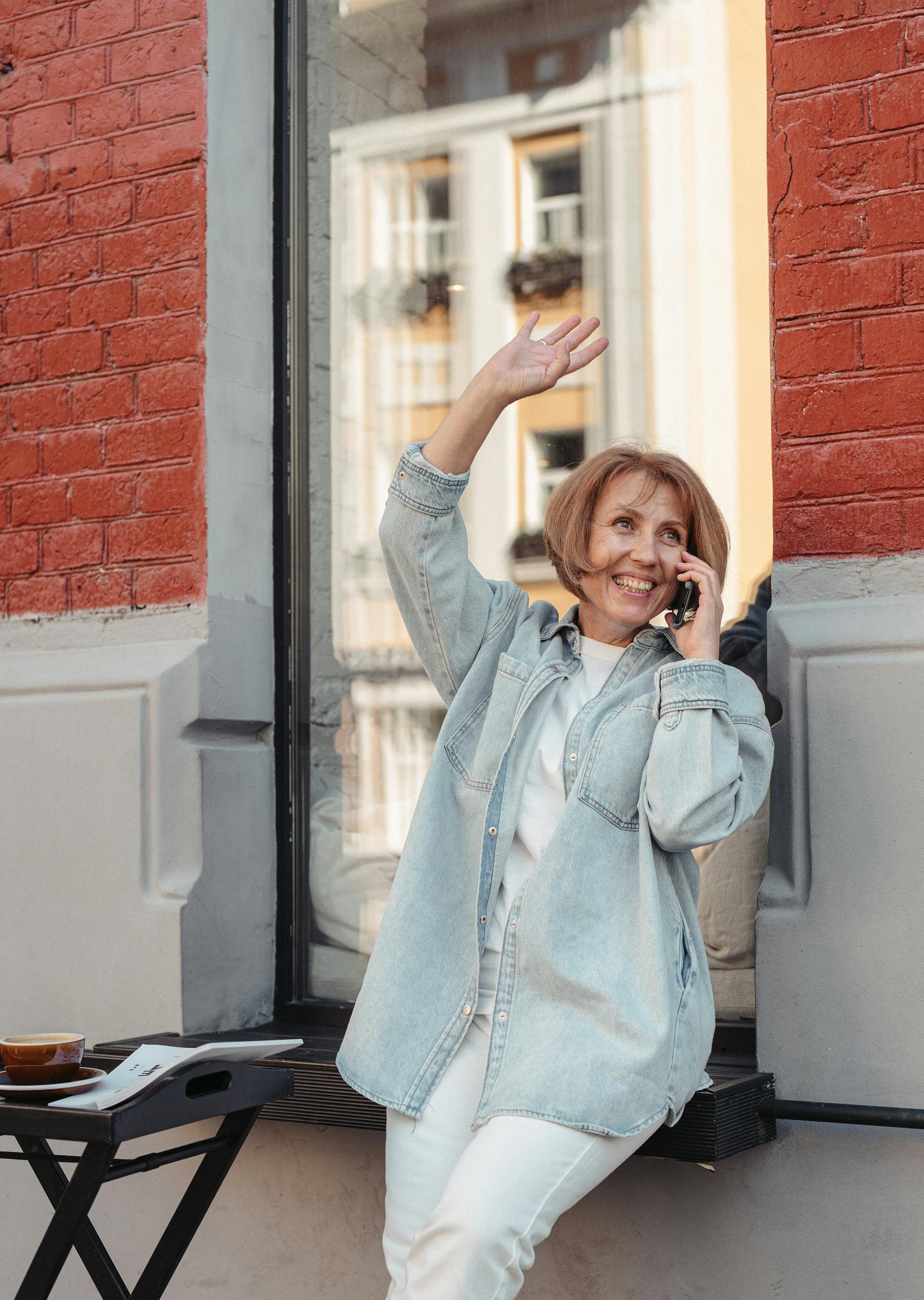 My Stepfather Told My Mom She Didn't Need Pretty Clothes Anymore – It Was His Biggest Mistake 17 A woman smiling and waving while on a call | Source: Pexels