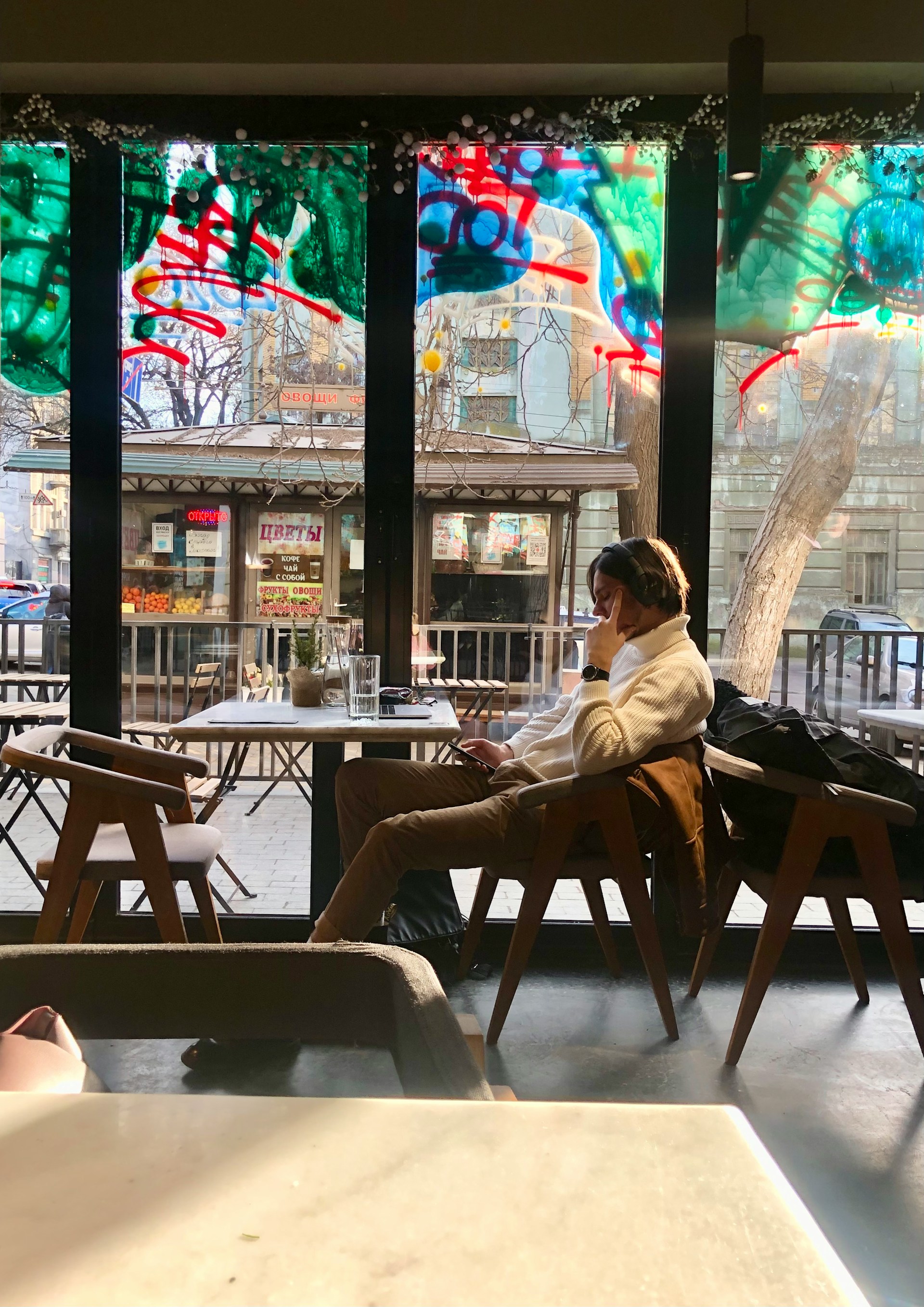 A young man sitting in a coffee shop | Source: Unsplash