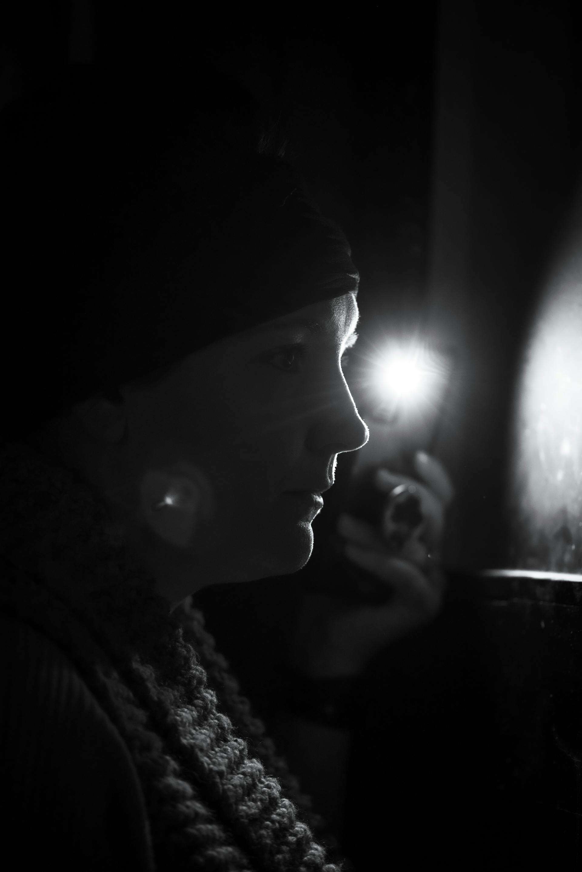 A woman using her phone flashlight | Source: Pexels