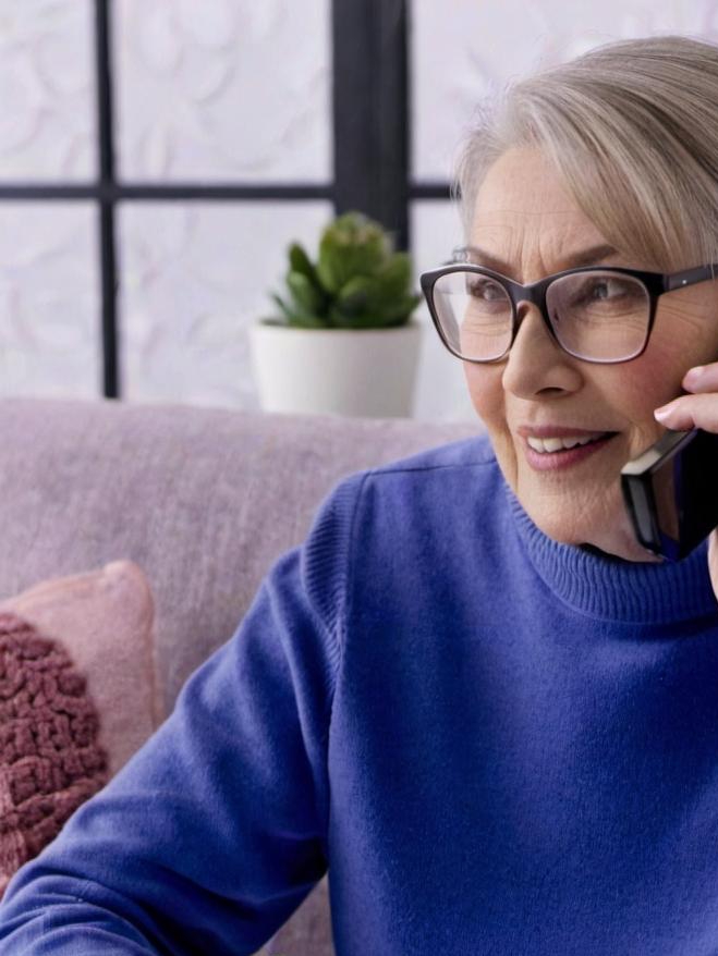 An elderly woman placing a phone call | Source: Midjourney